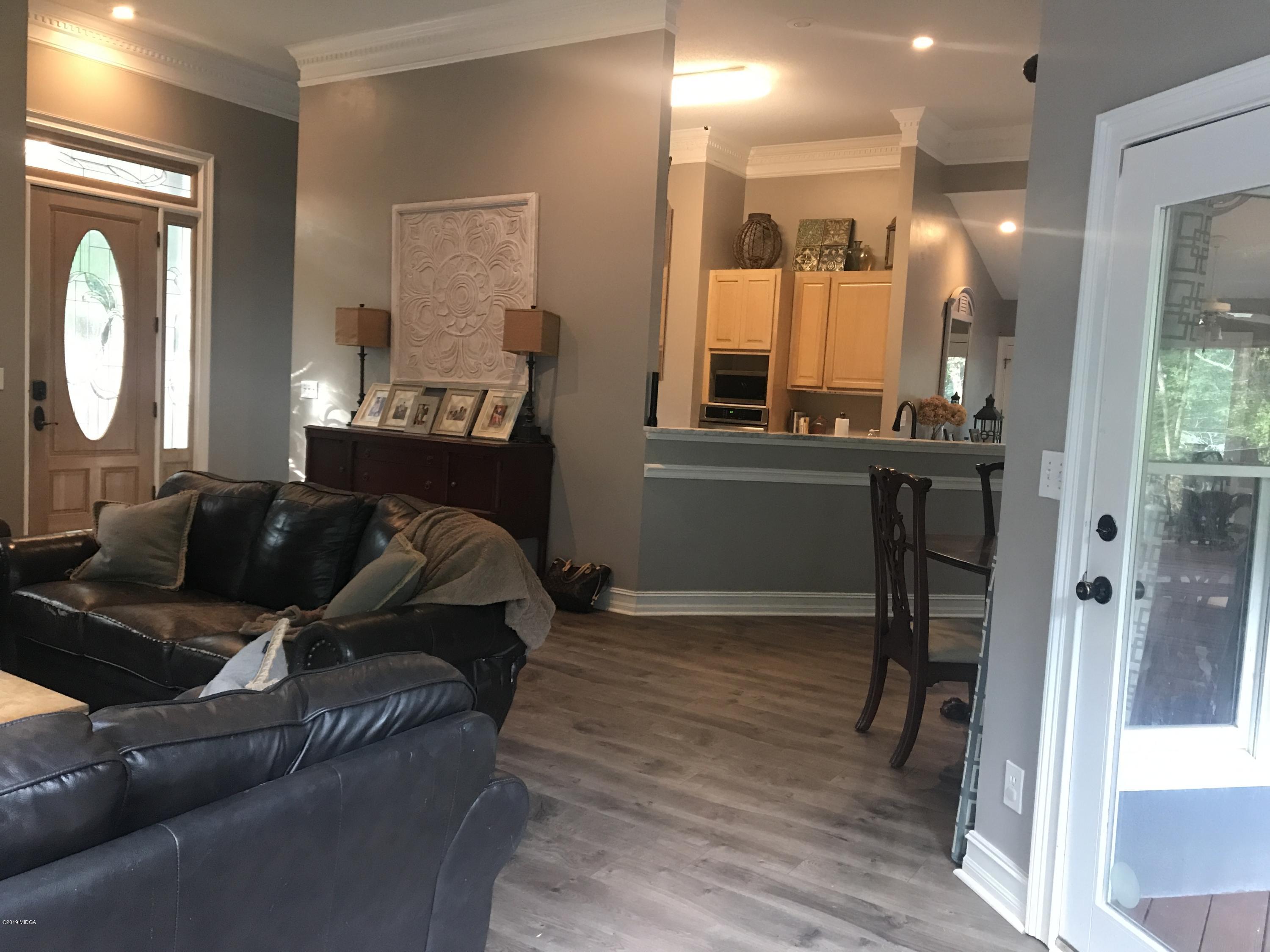 1569 Johnson Road Macon, GA 31220 - Photo 15 of 28 a living room with furniture and a large mirror next to a window