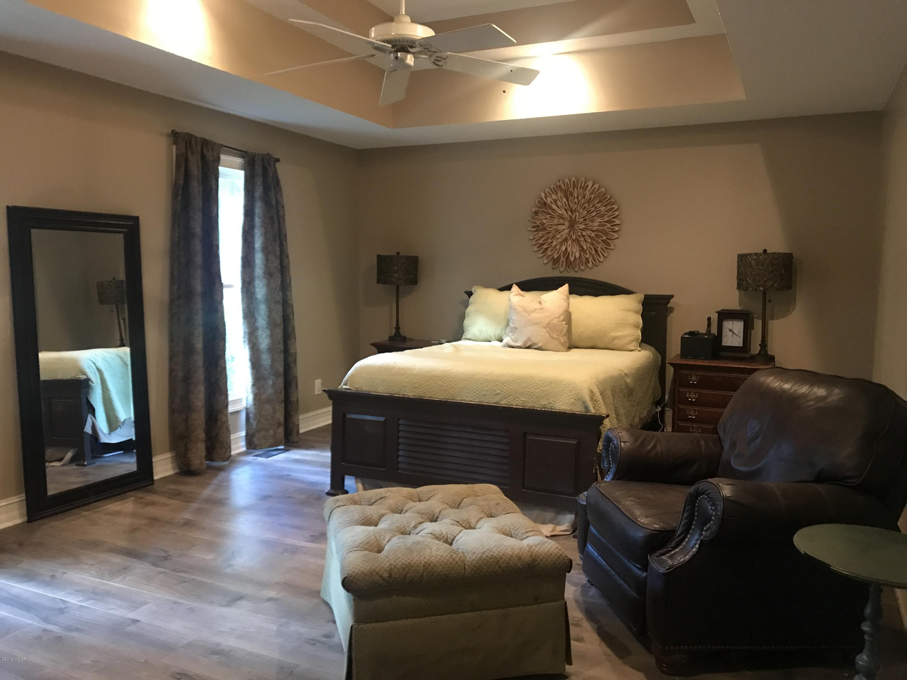 1569 Johnson Road Macon, GA 31220 - Photo 4 of 28 a bedroom with bed and a couch