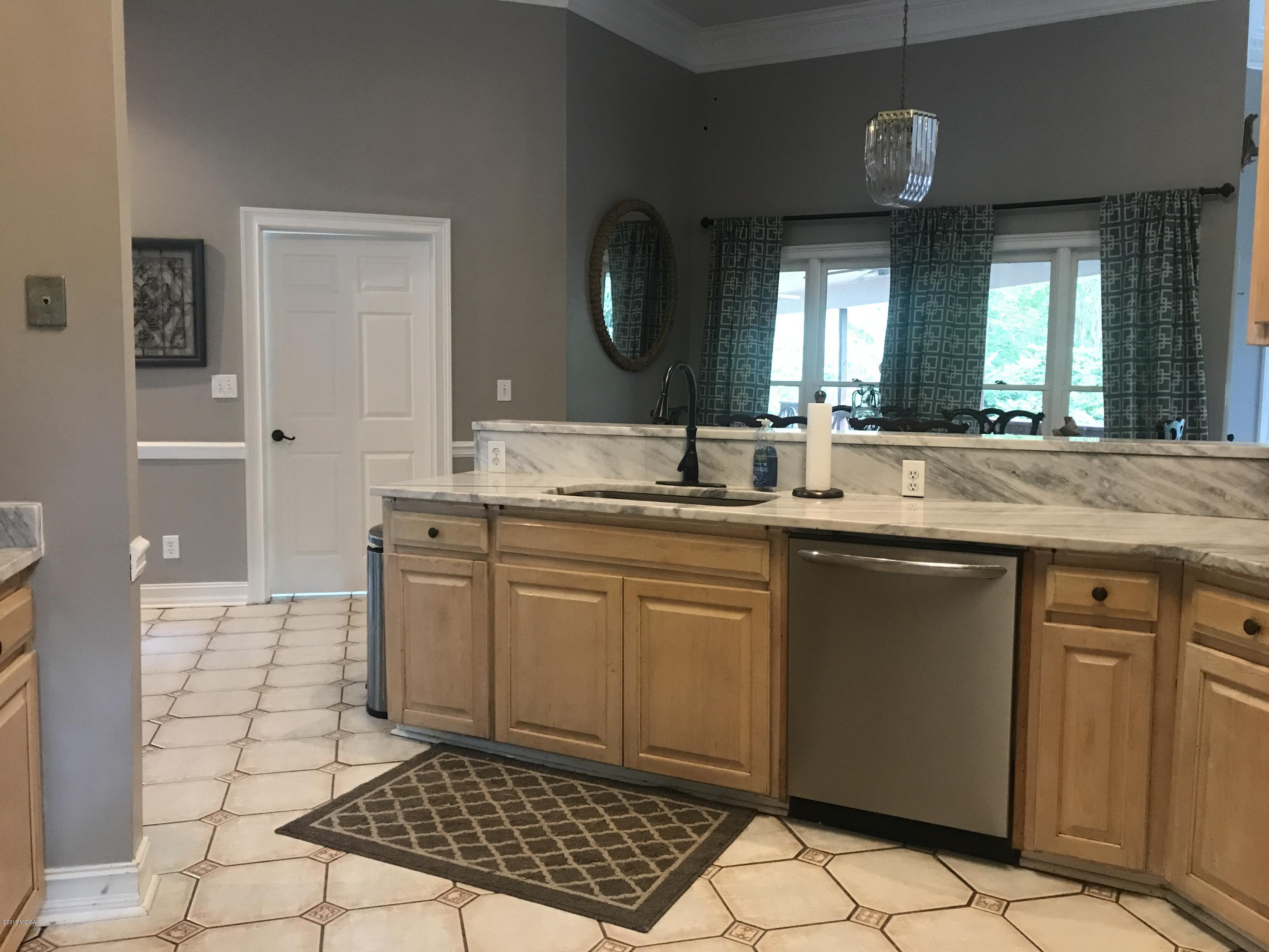 1569 Johnson Road Macon, GA 31220 - Photo 10 of 28 a kitchen with a sink stove and cabinets