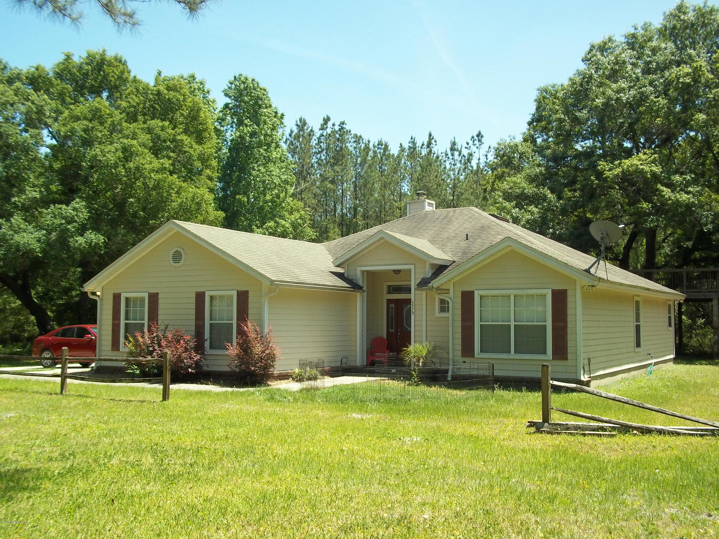 5579 Long Branch Road Jacksonville, FL 32234 - Photo 1 of 54 a big house with a big yard and potted plants in front of it