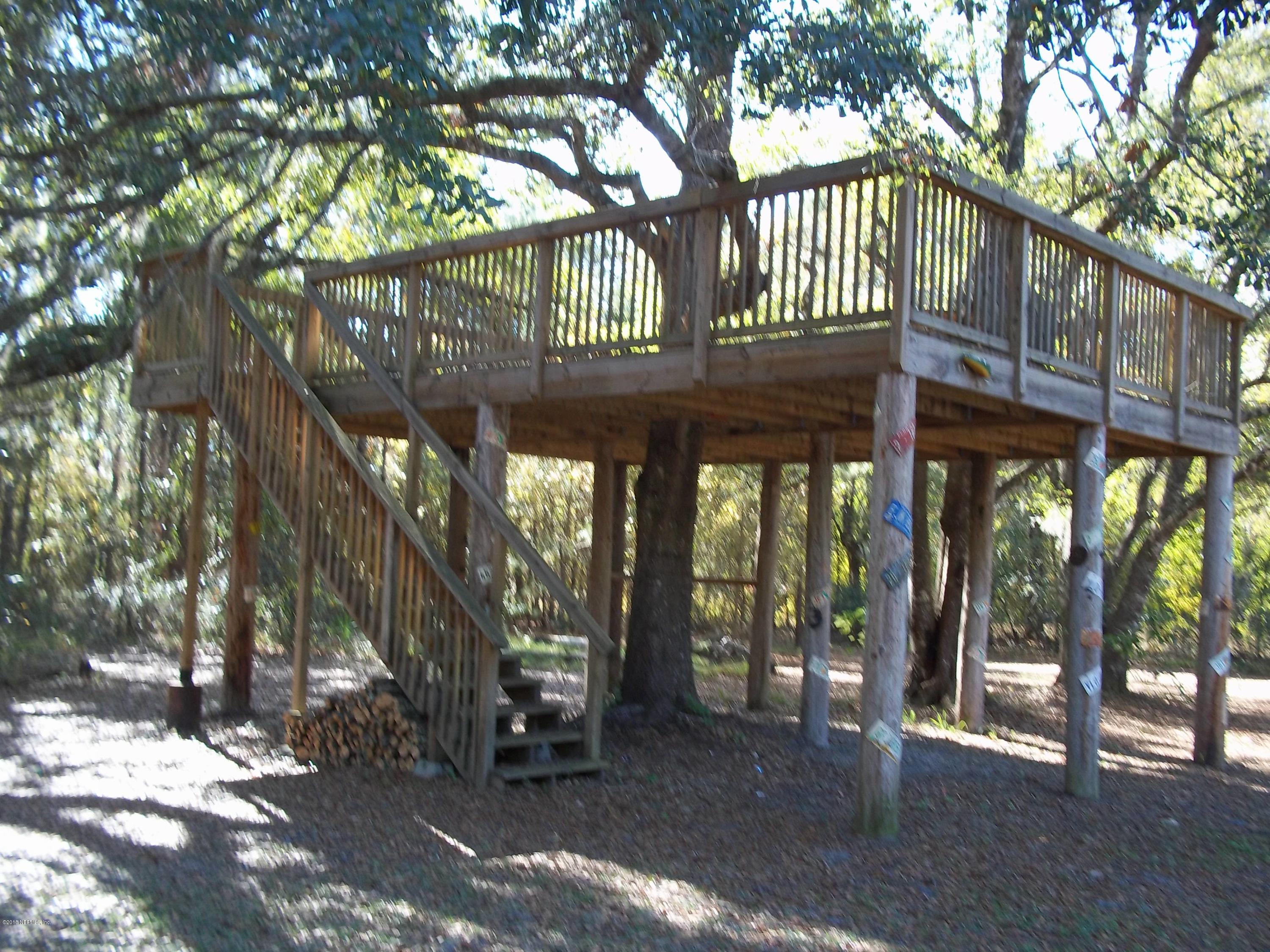 5579 Long Branch Road Jacksonville, FL 32234 - Photo 12 of 54 a view of a house with a large tree