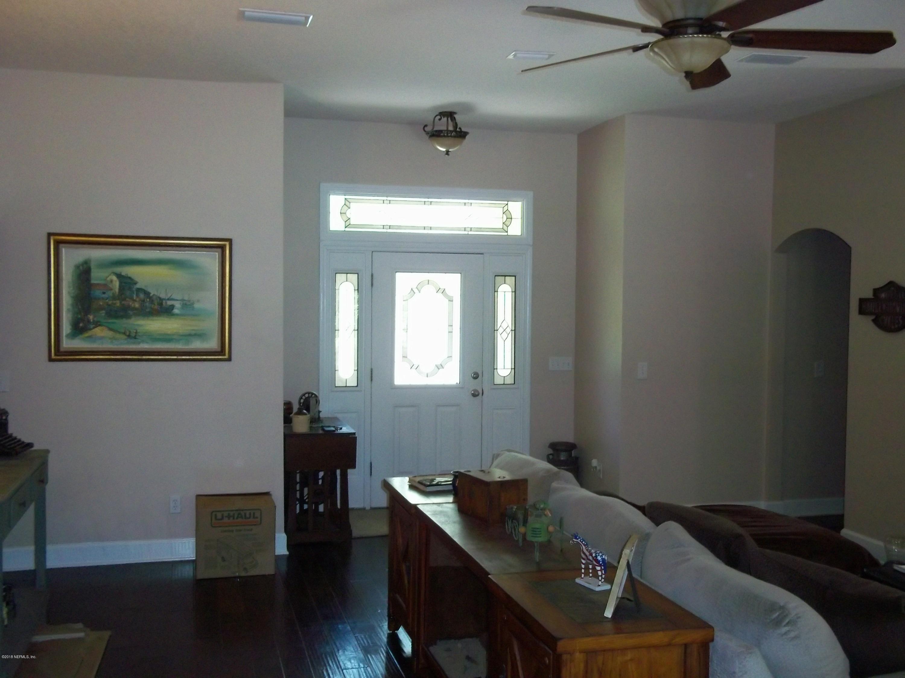 5579 Long Branch Road Jacksonville, FL 32234 - Photo 15 of 54 a view of a workspace with furniture and wooden floor