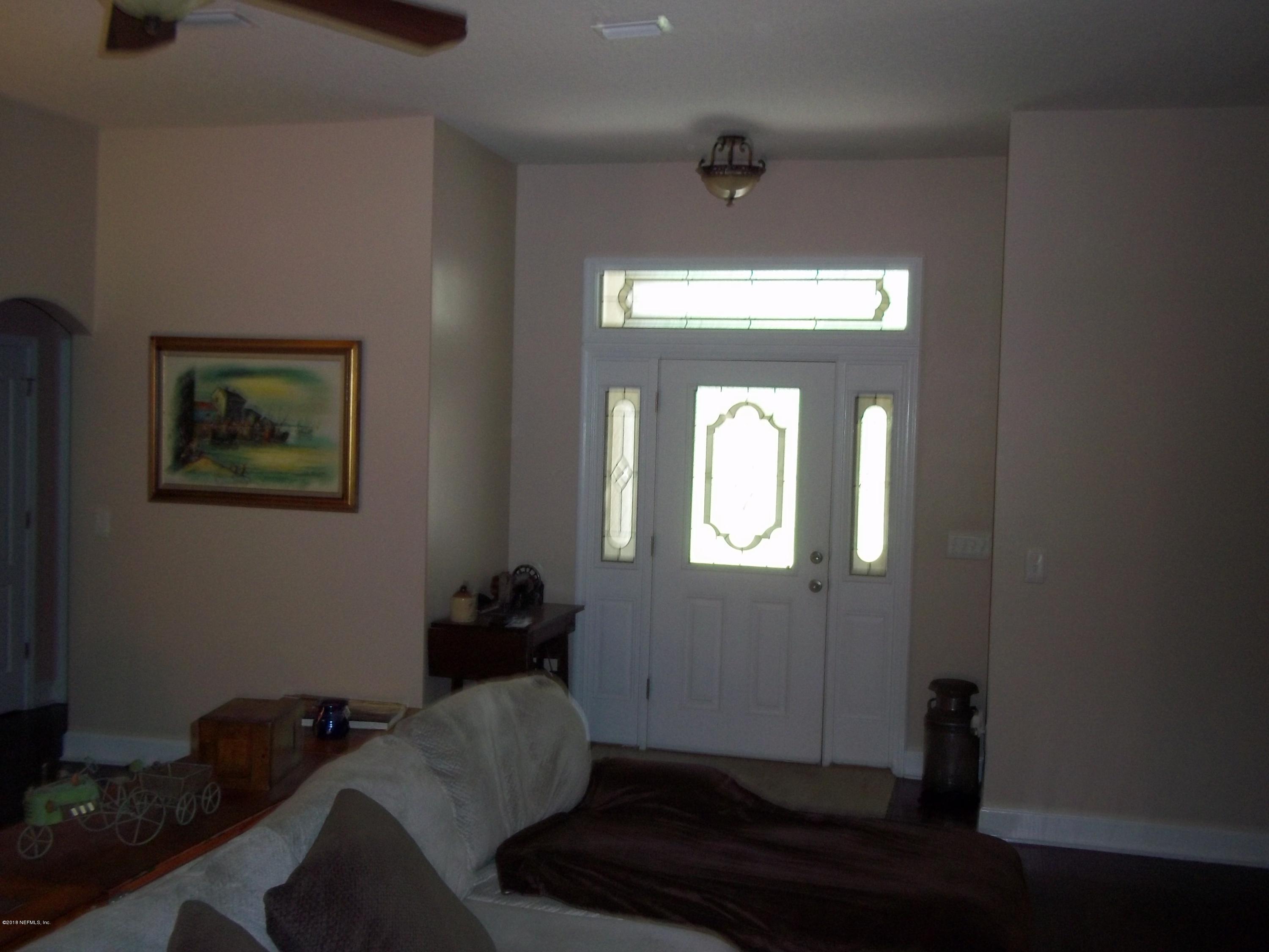 5579 Long Branch Road Jacksonville, FL 32234 - Photo 17 of 54 a living room with furniture and a window