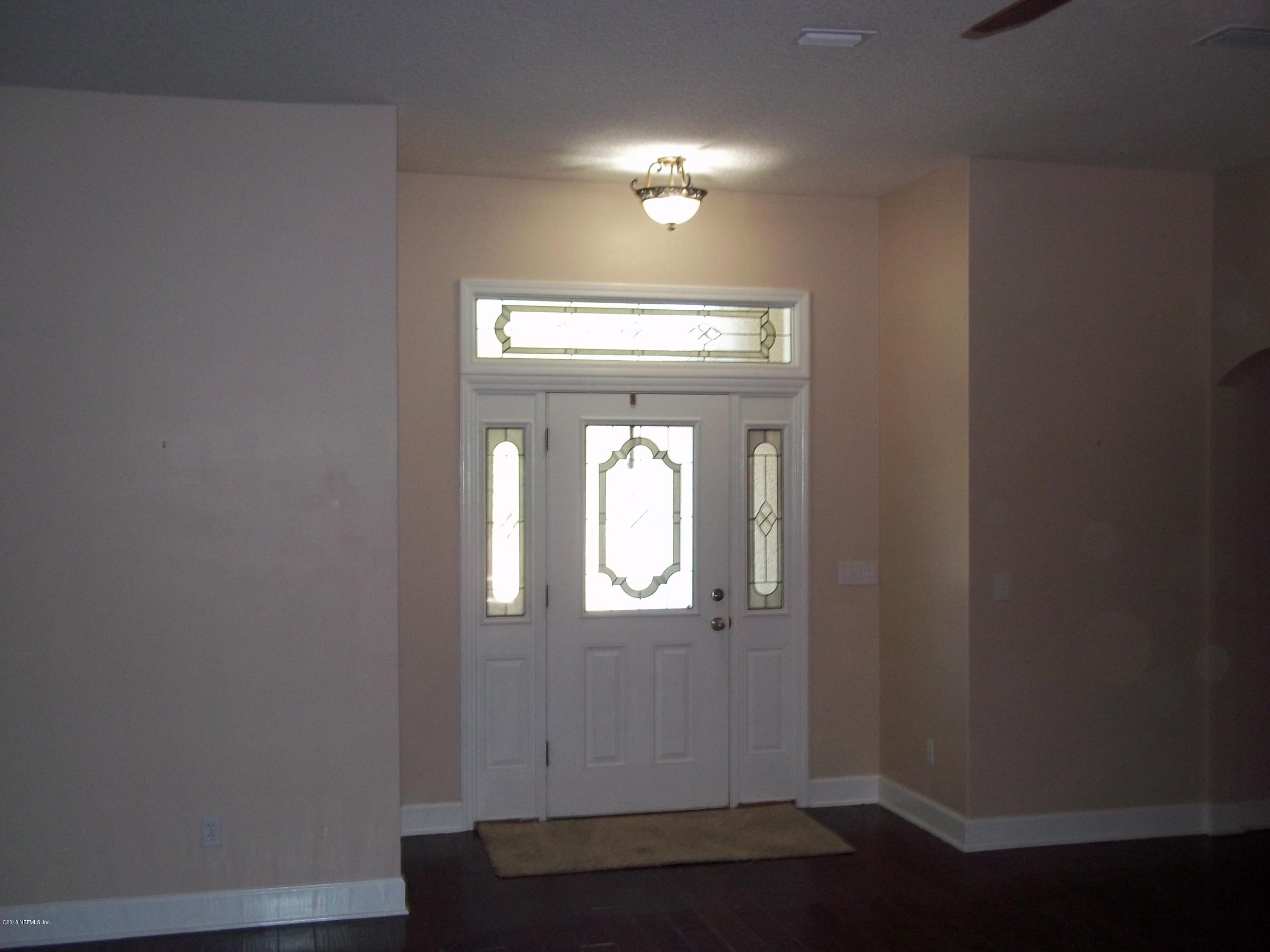 5579 Long Branch Road Jacksonville, FL 32234 - Photo 18 of 54 a view of a livingroom with wooden floor and a window