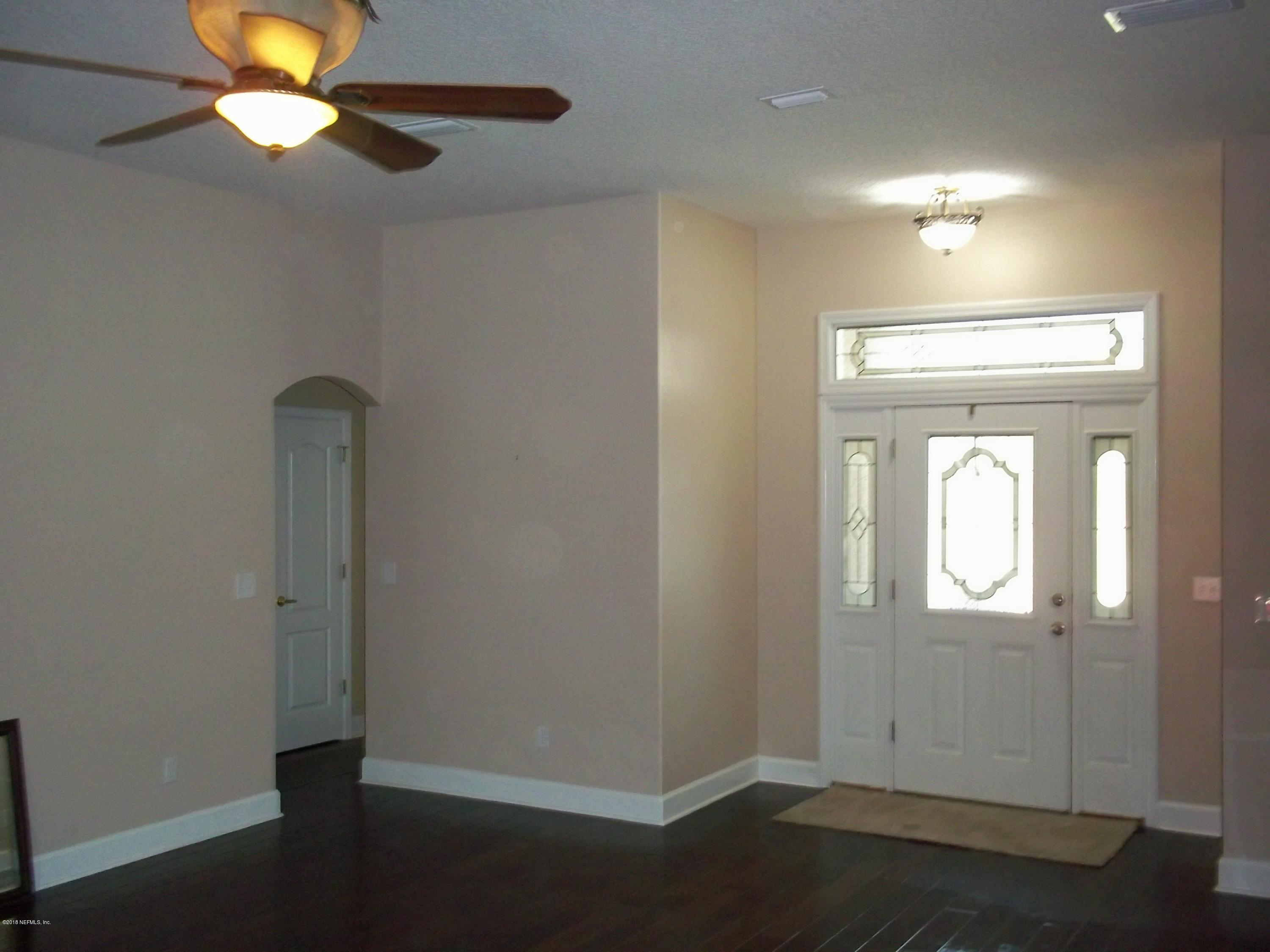 5579 Long Branch Road Jacksonville, FL 32234 - Photo 19 of 54 wooden floor in an empty room with a window