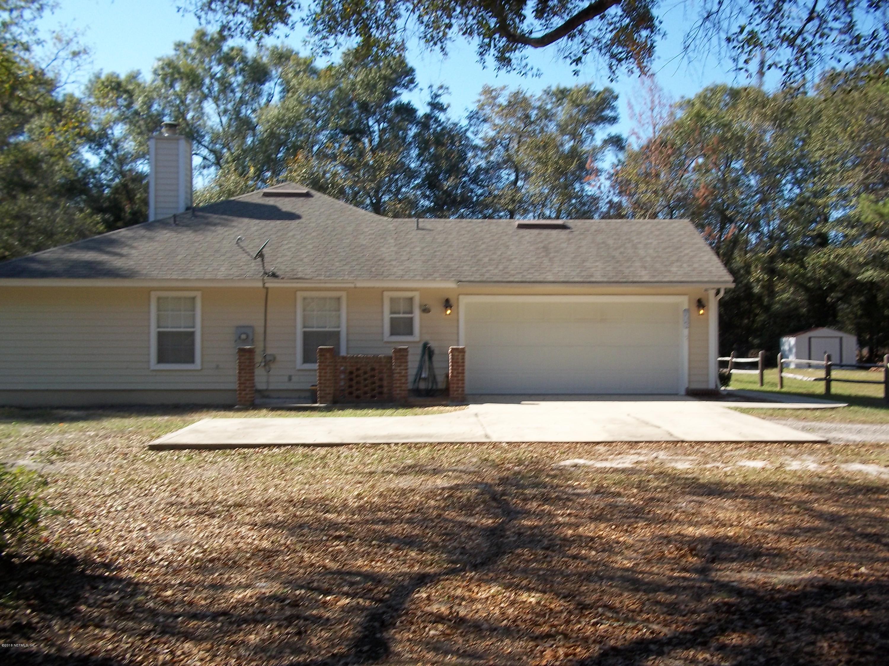 5579 Long Branch Road Jacksonville, FL 32234 - Photo 2 of 54 a front view of a house with a yard