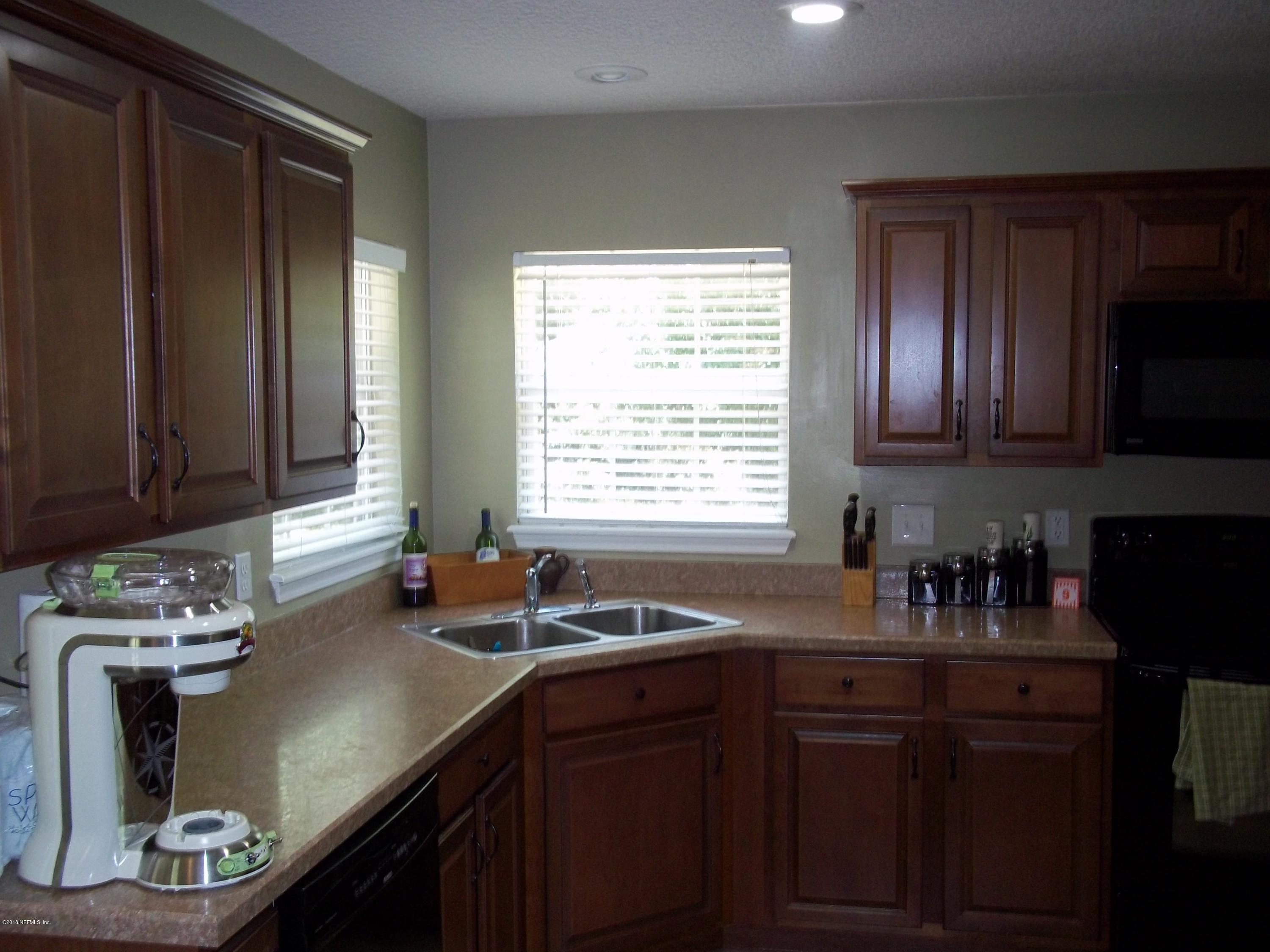 5579 Long Branch Road Jacksonville, FL 32234 - Photo 21 of 54 a kitchen with a sink cabinets and window