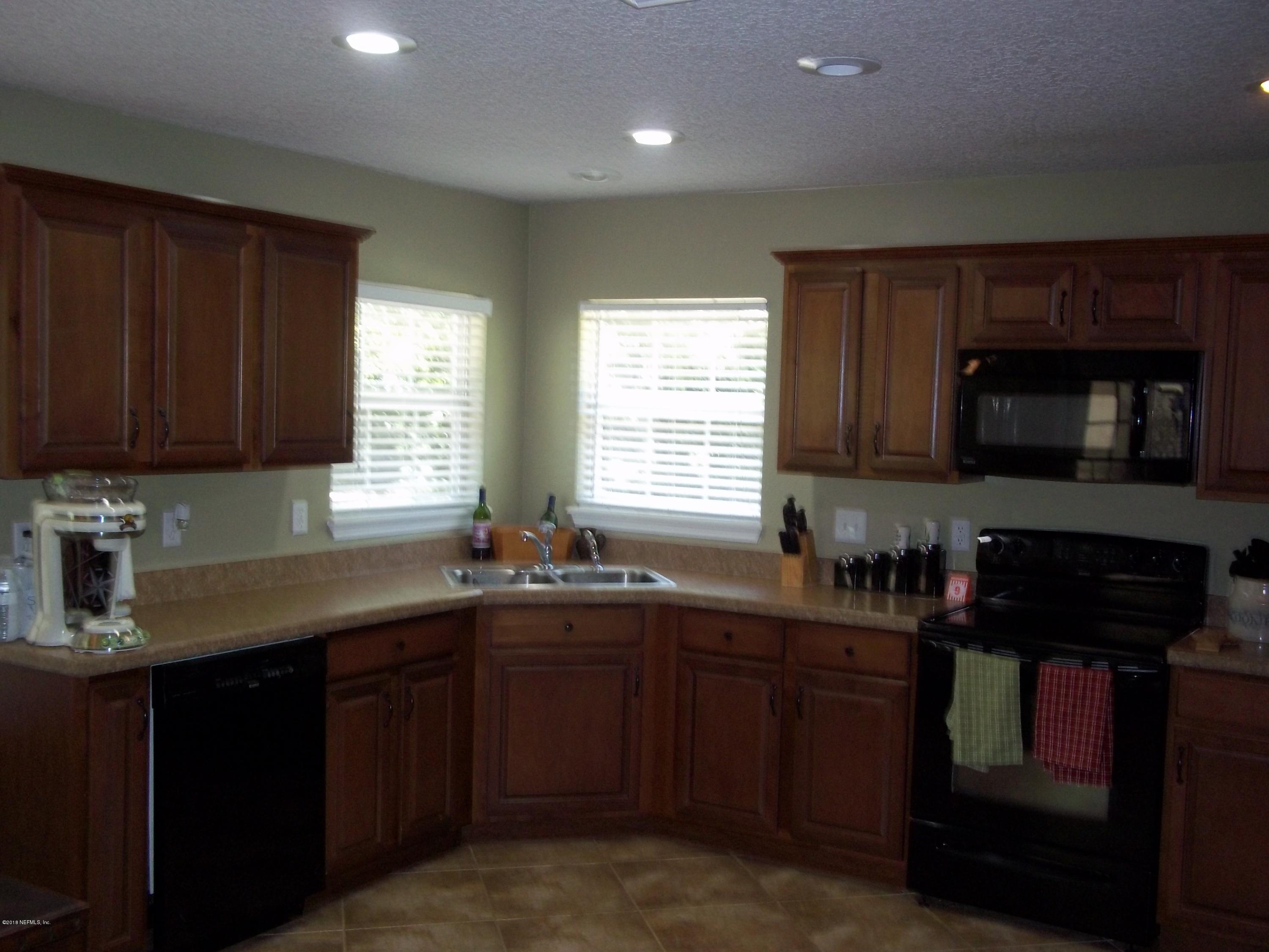 5579 Long Branch Road Jacksonville, FL 32234 - Photo 23 of 54 a kitchen with sink cabinets and window