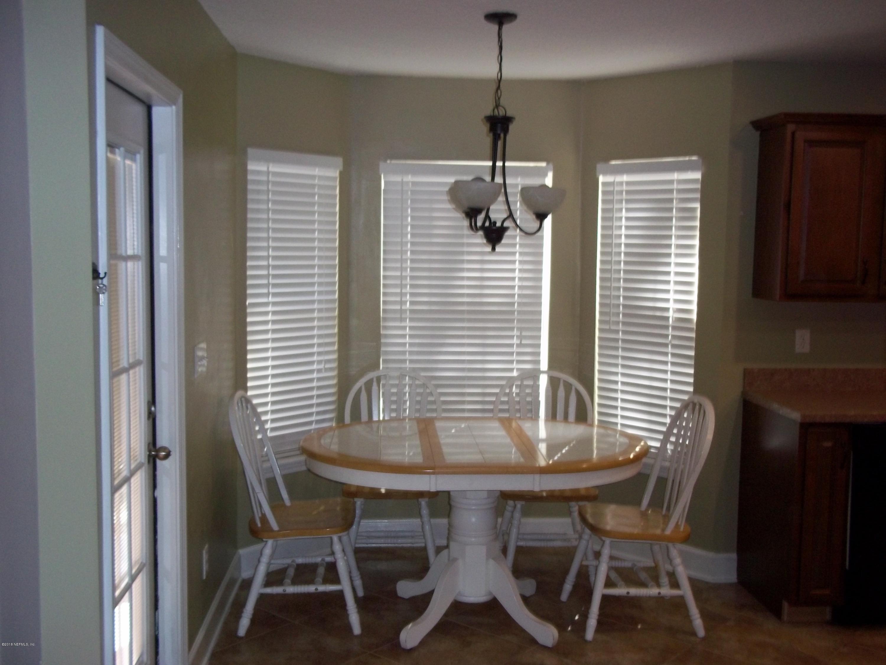 5579 Long Branch Road Jacksonville, FL 32234 - Photo 24 of 54 a view of a dining room with furniture and window