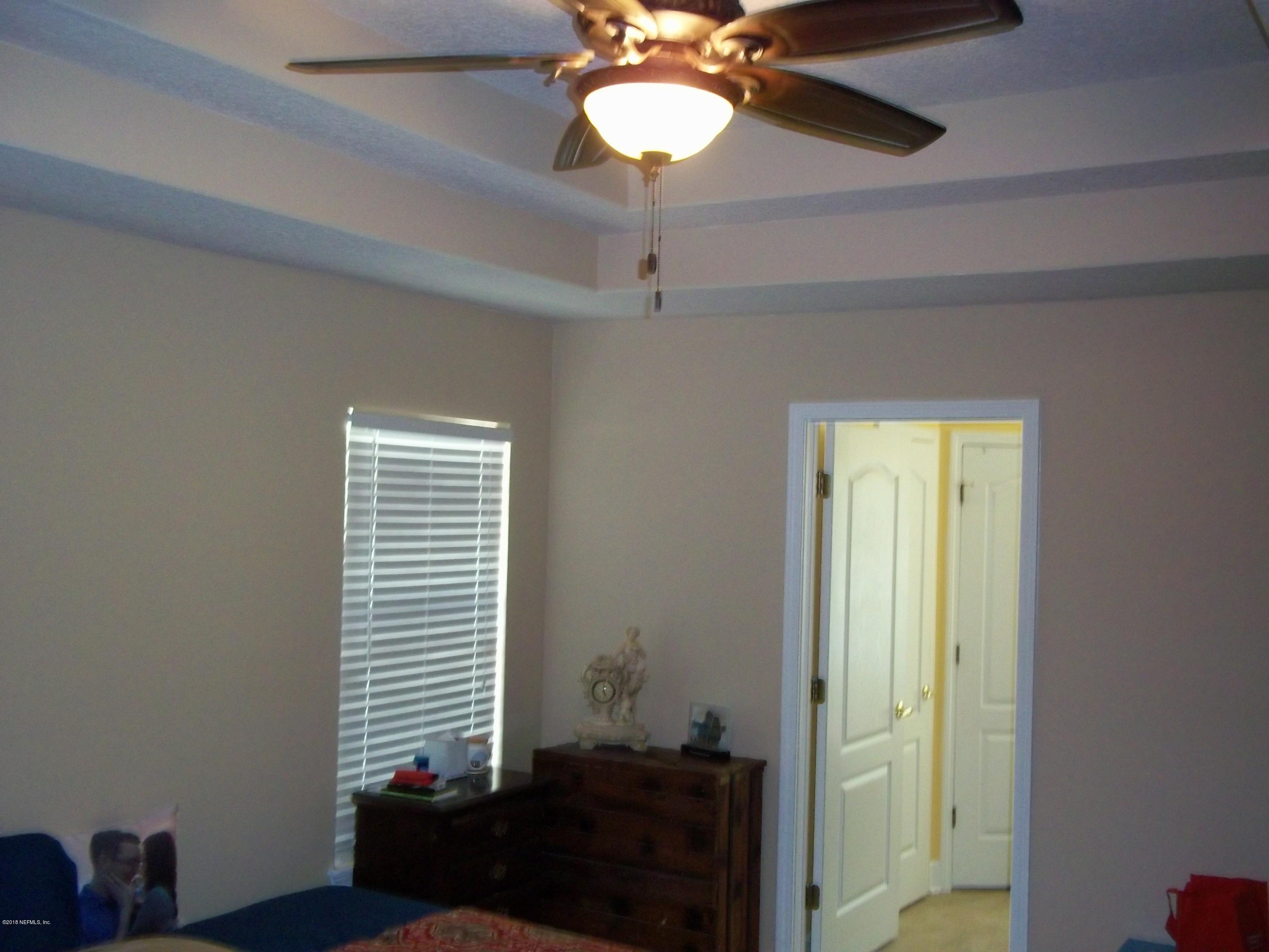 5579 Long Branch Road Jacksonville, FL 32234 - Photo 26 of 54 a view of a room with a windows and ceiling fan