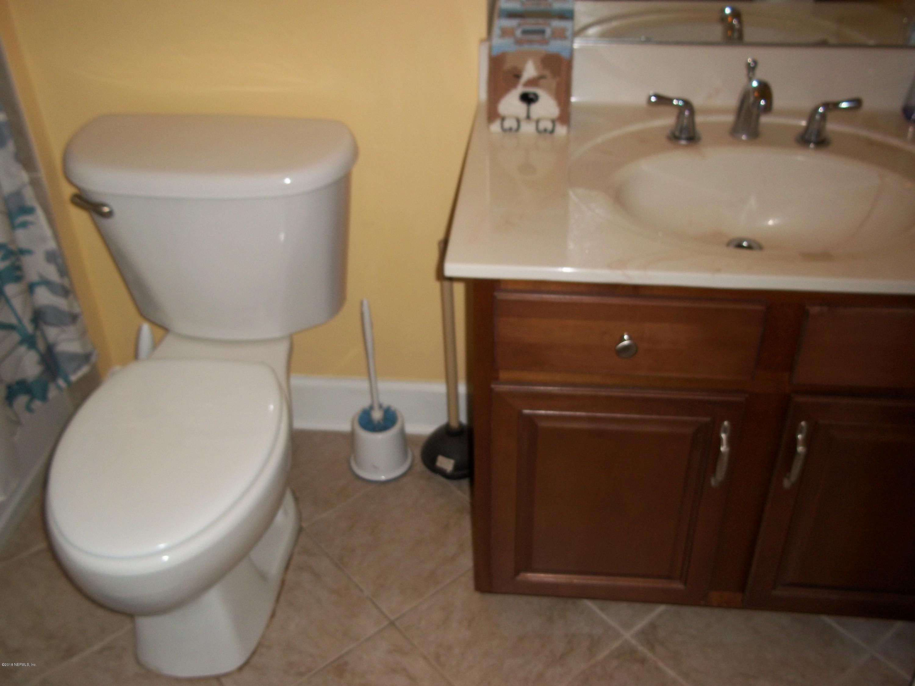 5579 Long Branch Road Jacksonville, FL 32234 - Photo 28 of 54 a bathroom with a toilet and a sink