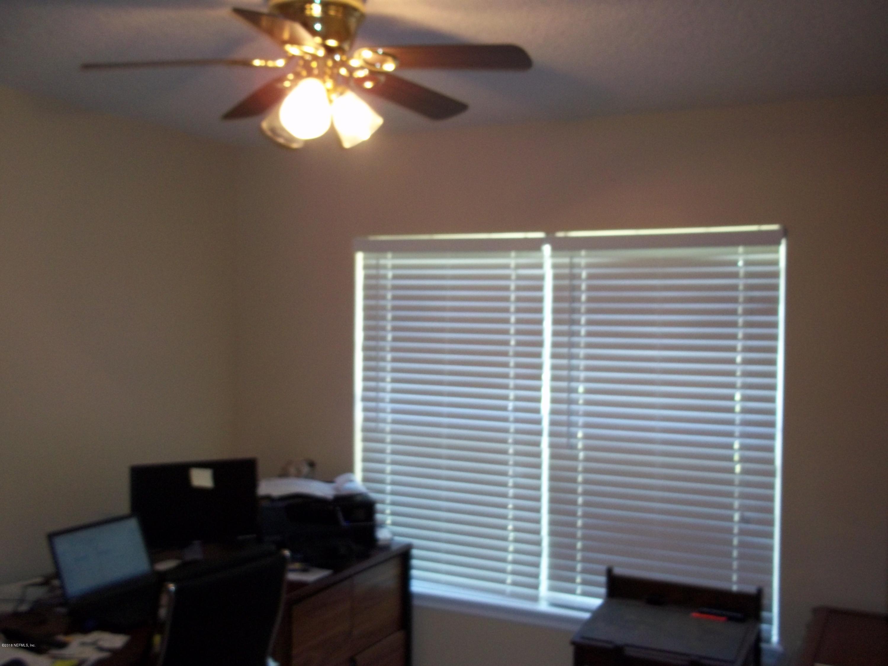 5579 Long Branch Road Jacksonville, FL 32234 - Photo 29 of 54 a view of a workspace with furniture and a window