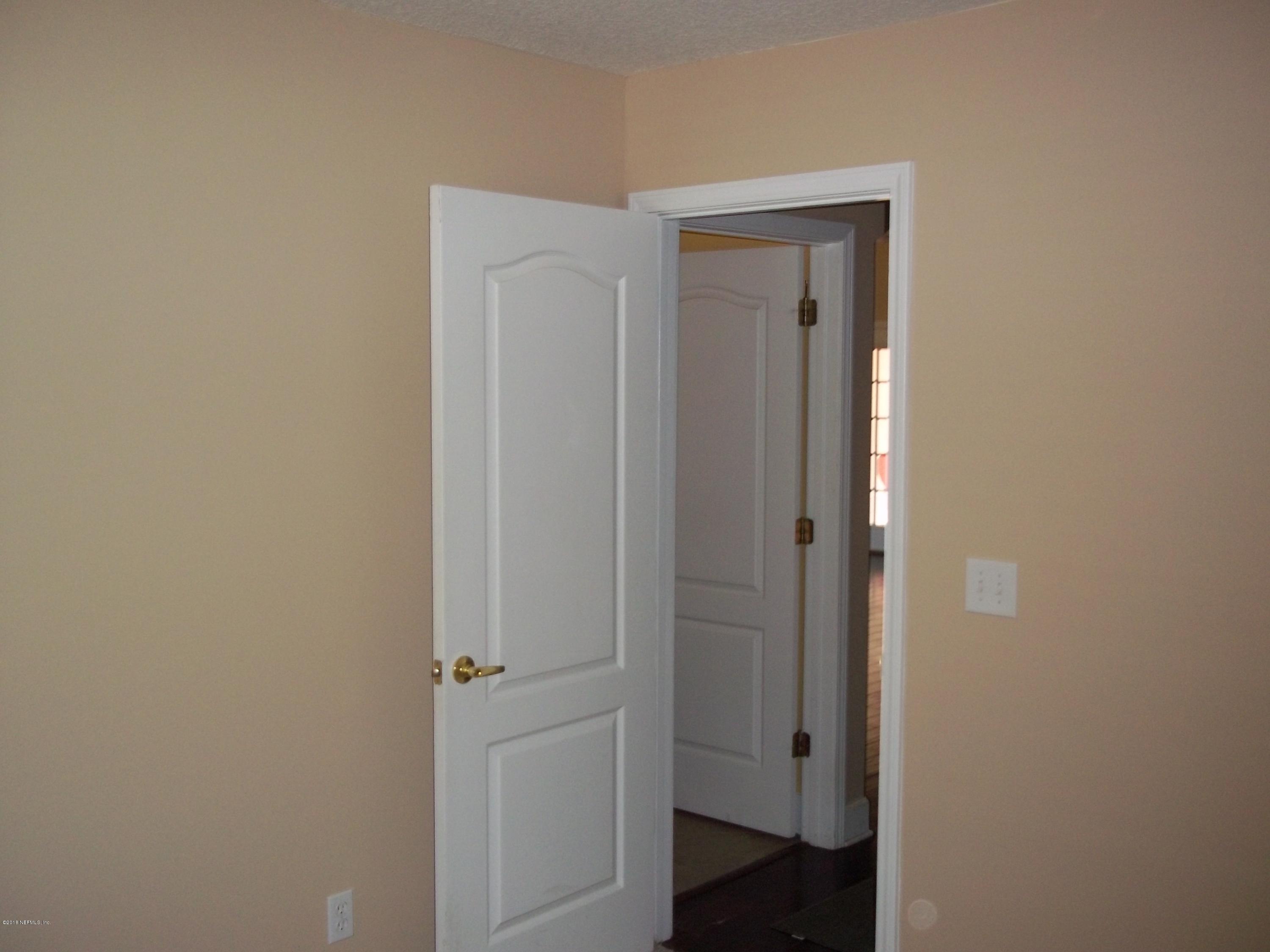 5579 Long Branch Road Jacksonville, FL 32234 - Photo 30 of 54 a view of a hallway with wooden floor