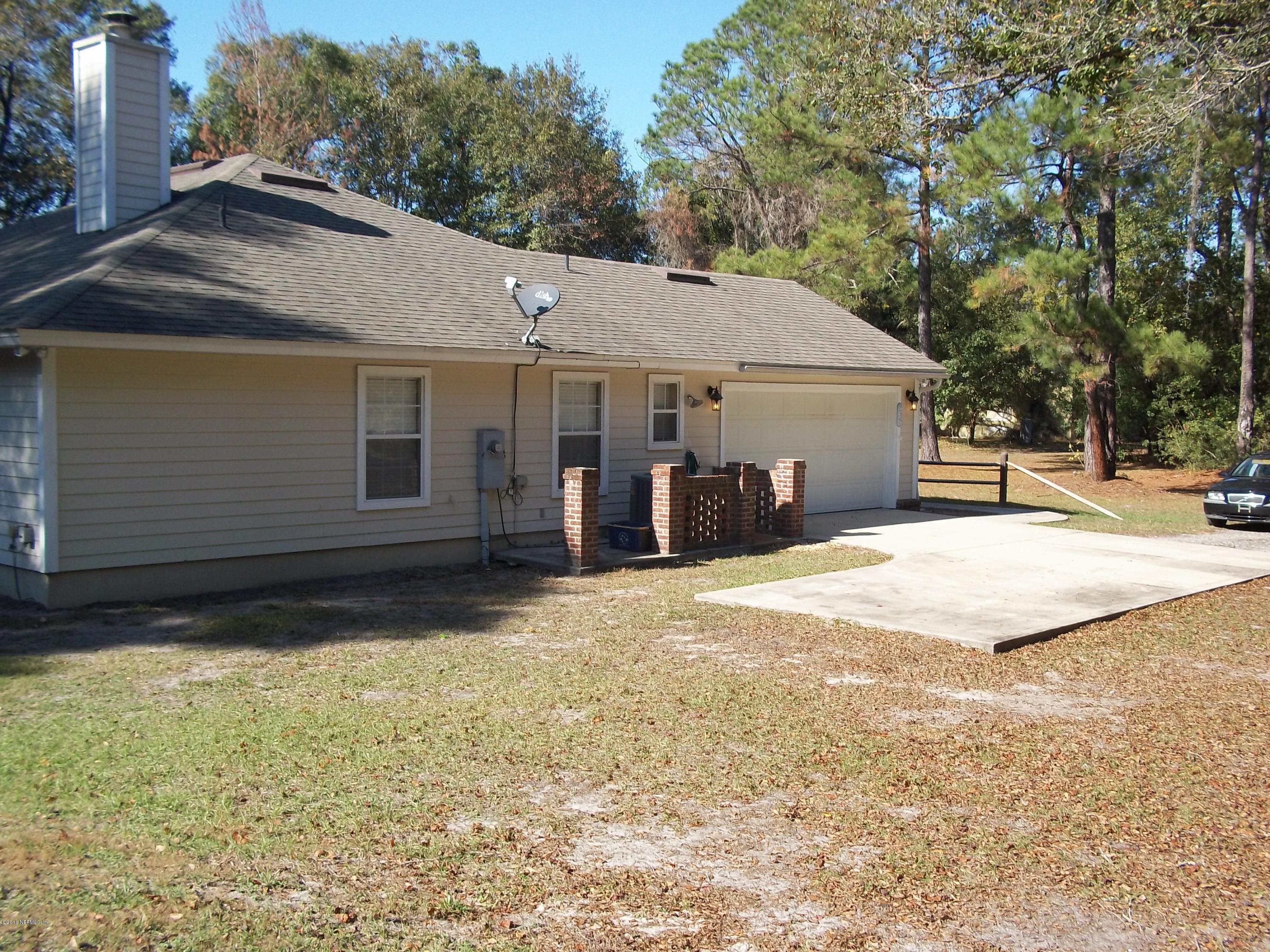 5579 Long Branch Road Jacksonville, FL 32234 - Photo 3 of 54 a view of a house with a yard and garage