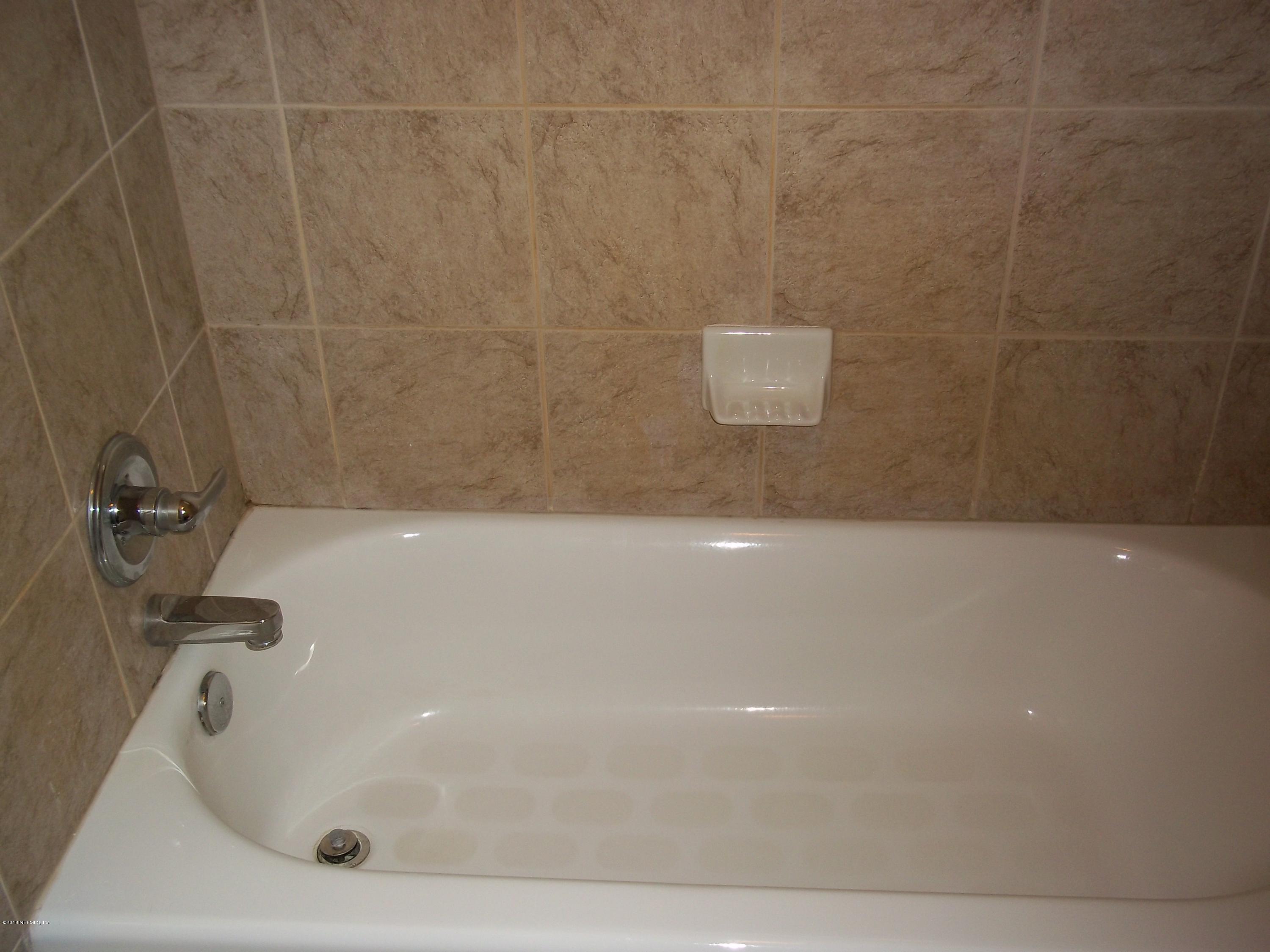 5579 Long Branch Road Jacksonville, FL 32234 - Photo 34 of 54 a bathroom with a bathtub