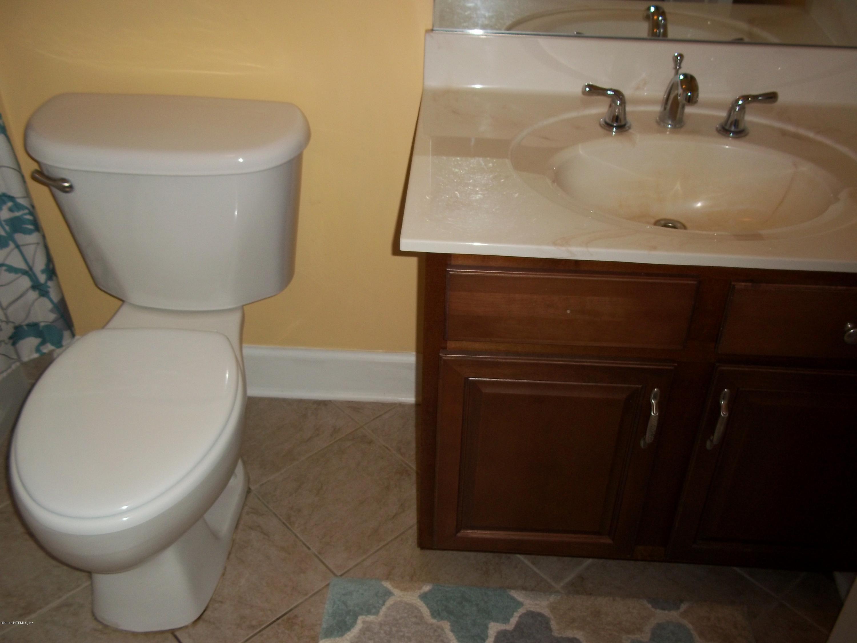 5579 Long Branch Road Jacksonville, FL 32234 - Photo 35 of 54 a bathroom with a toilet and a sink
