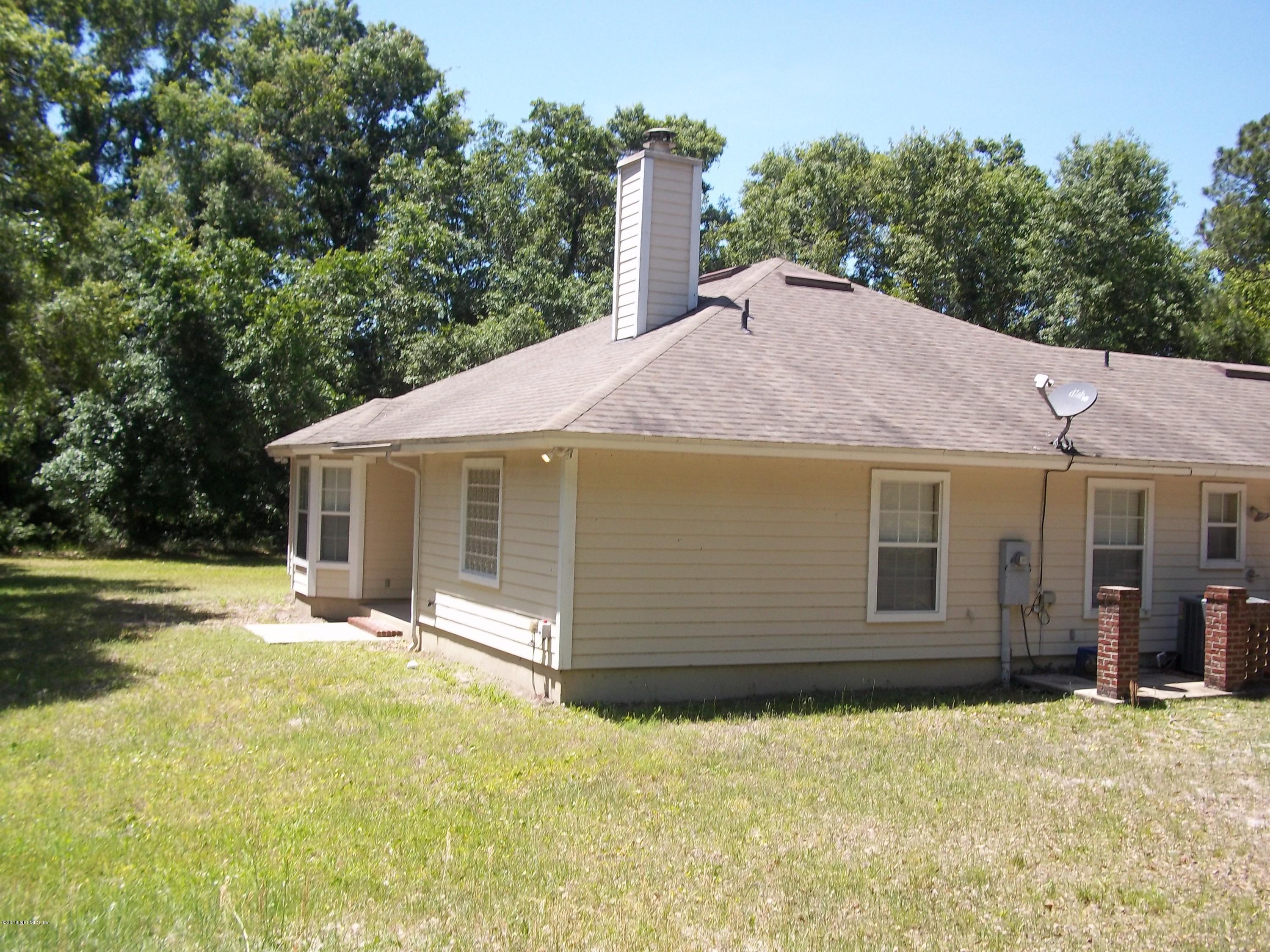 5579 Long Branch Road Jacksonville, FL 32234 - Photo 4 of 54 a view of a house with a yard and garage