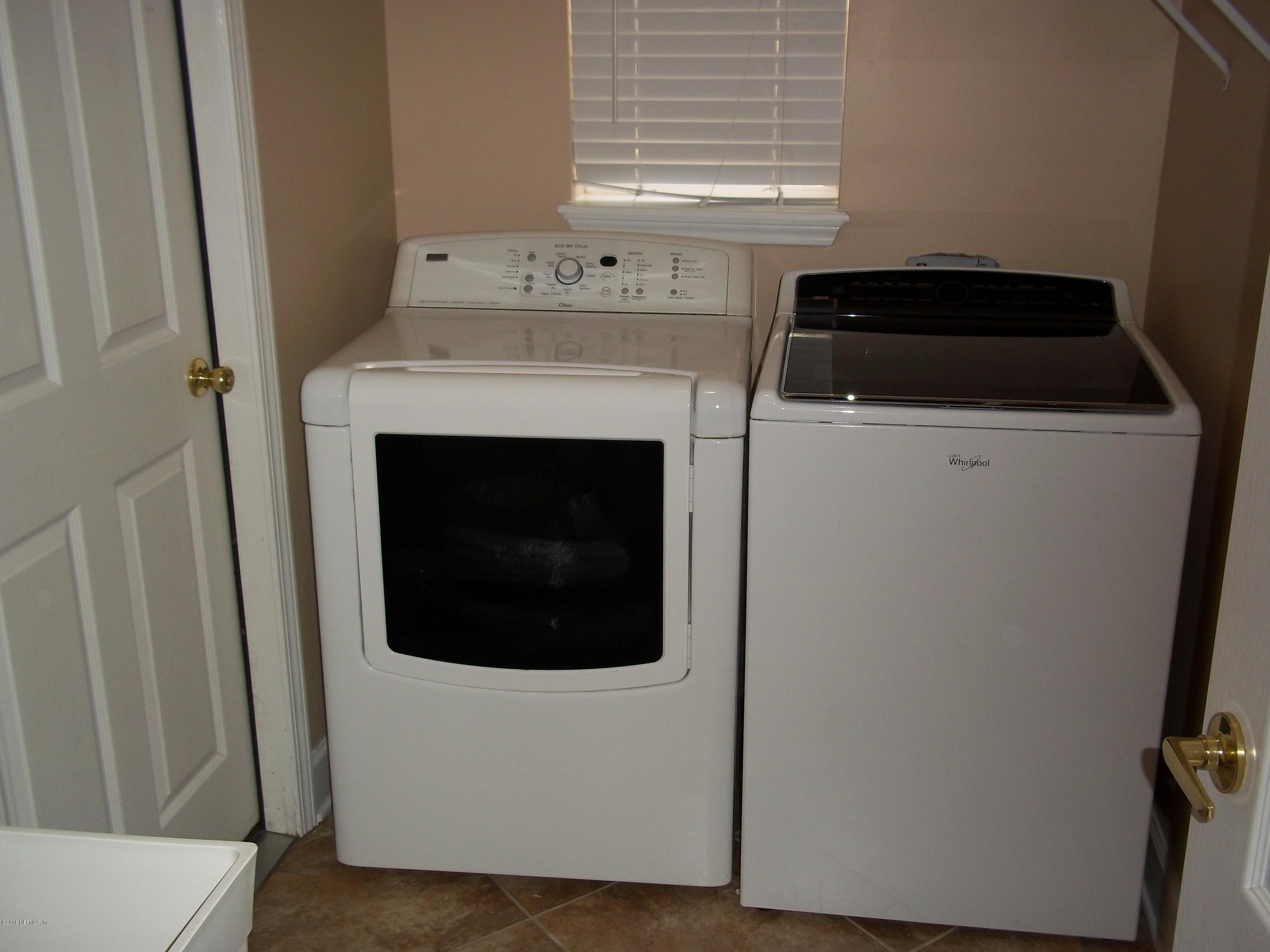 5579 Long Branch Road Jacksonville, FL 32234 - Photo 41 of 54 a utility room with dryer and washer
