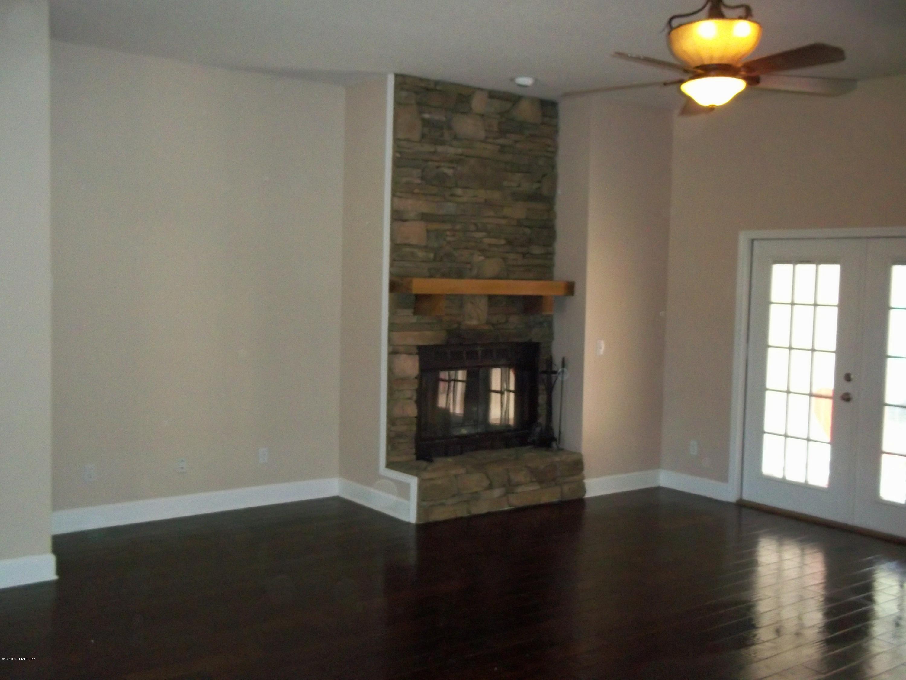 5579 Long Branch Road Jacksonville, FL 32234 - Photo 42 of 54 an empty room with wooden floor and windows