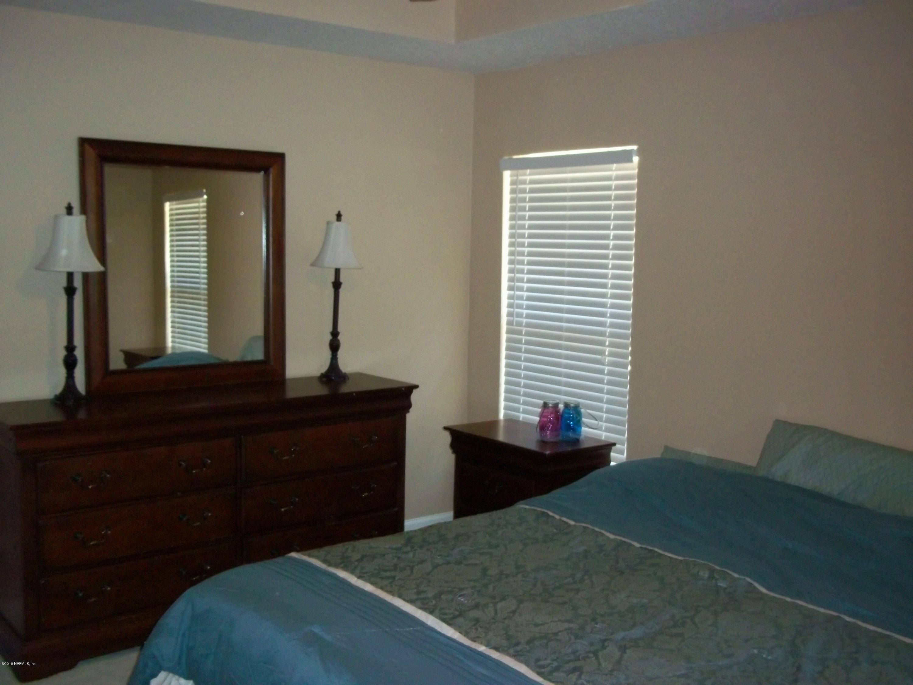 5579 Long Branch Road Jacksonville, FL 32234 - Photo 43 of 54 a bedroom with a bed and a dresser