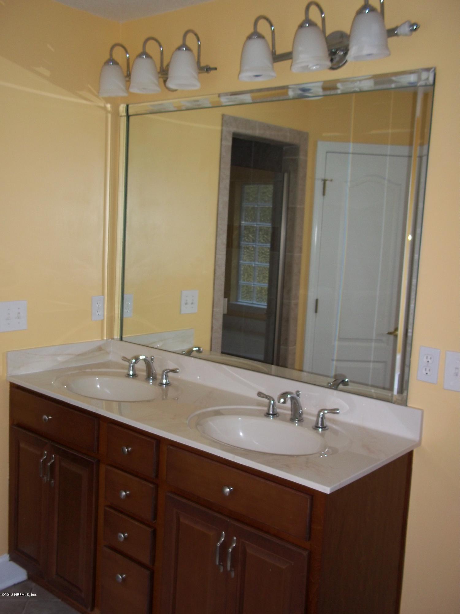 5579 Long Branch Road Jacksonville, FL 32234 - Photo 44 of 54 a bathroom with a granite countertop sink and a mirror