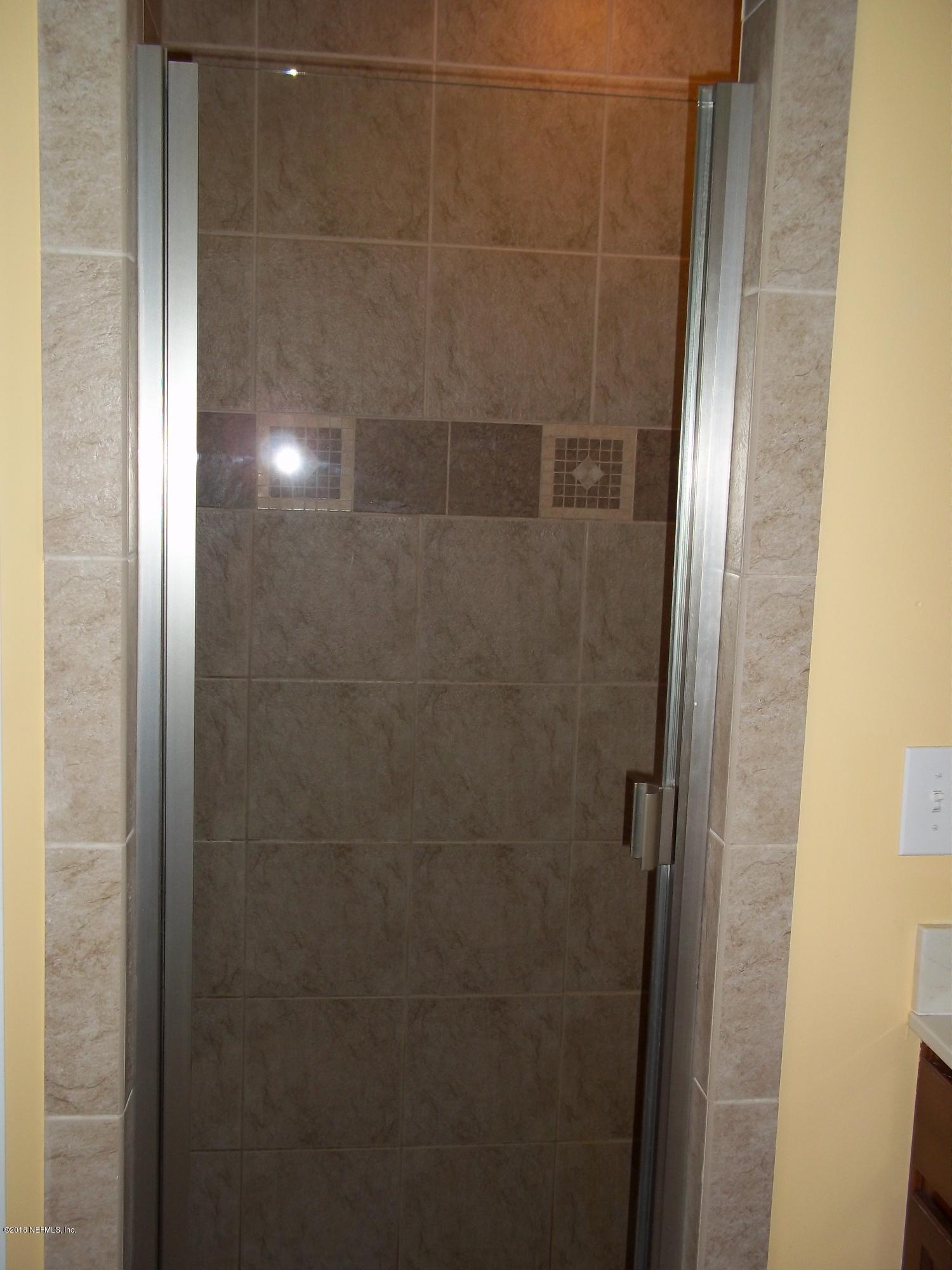 5579 Long Branch Road Jacksonville, FL 32234 - Photo 48 of 54 a bathroom with a glass door shower