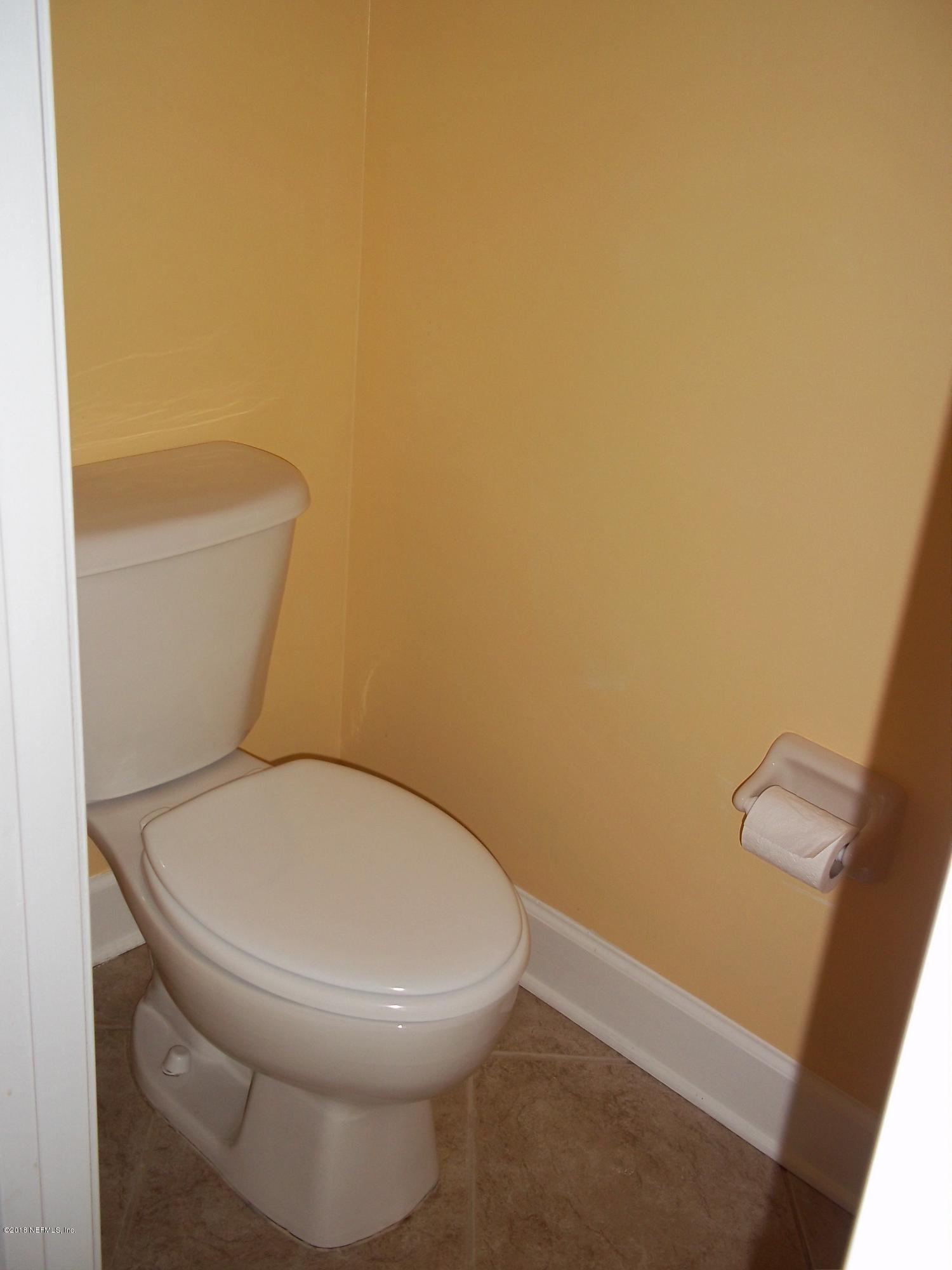 5579 Long Branch Road Jacksonville, FL 32234 - Photo 50 of 54 a white toilet sitting next to a white wall