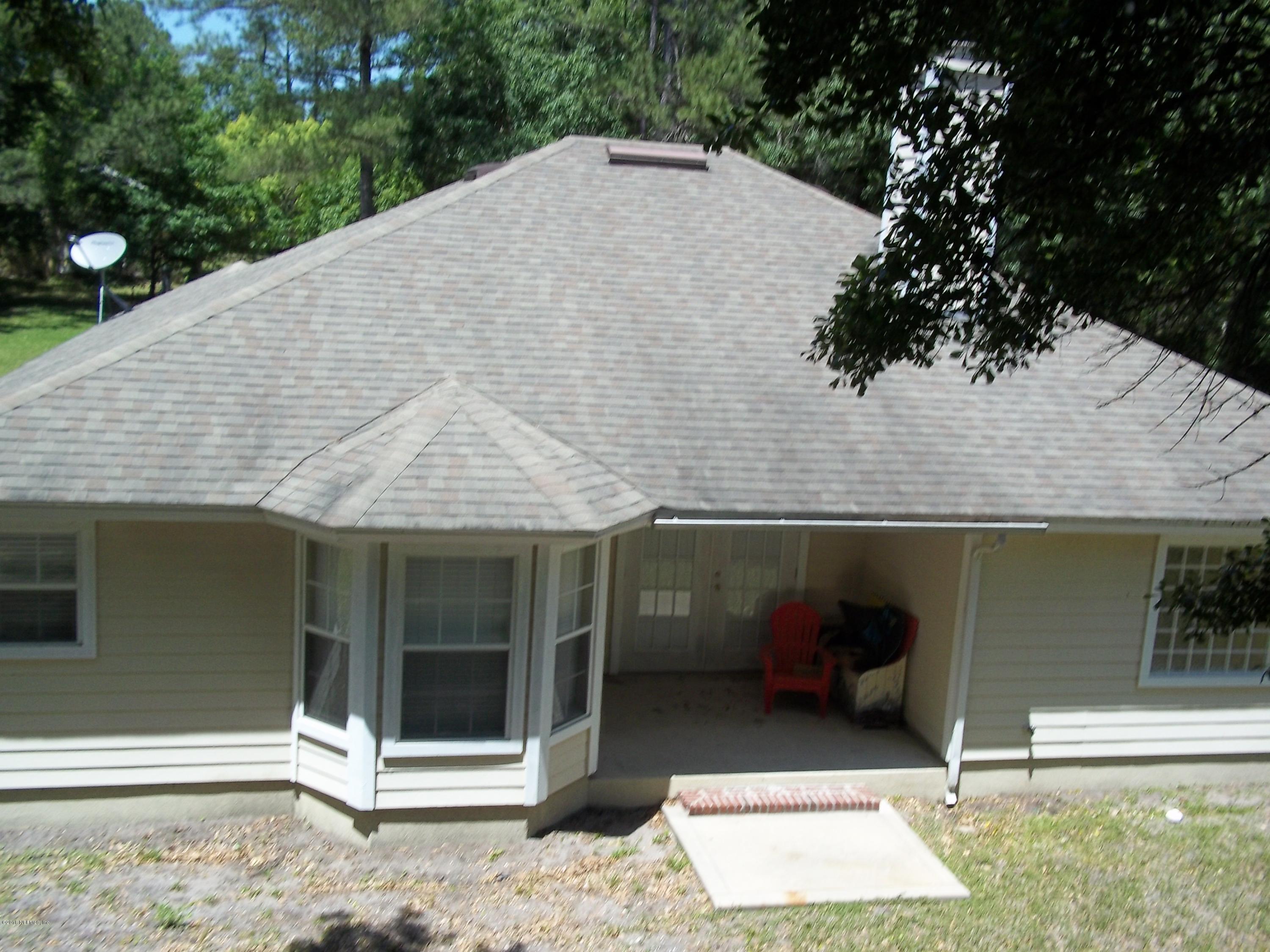 5579 Long Branch Road Jacksonville, FL 32234 - Photo 6 of 54 a view of a house with a backyard