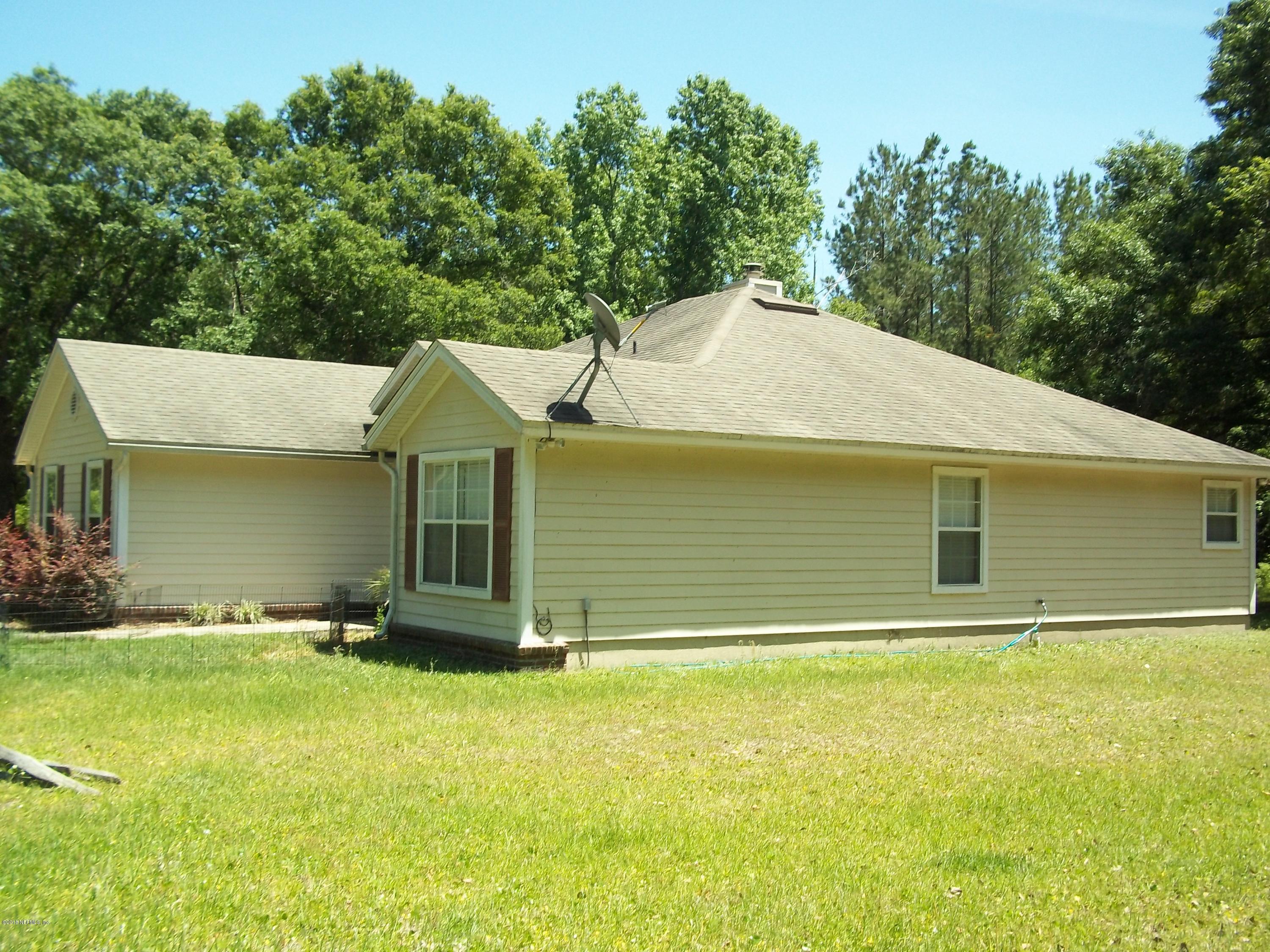 5579 Long Branch Road Jacksonville, FL 32234 - Photo 8 of 54 a backyard of a house with yard and trampoline