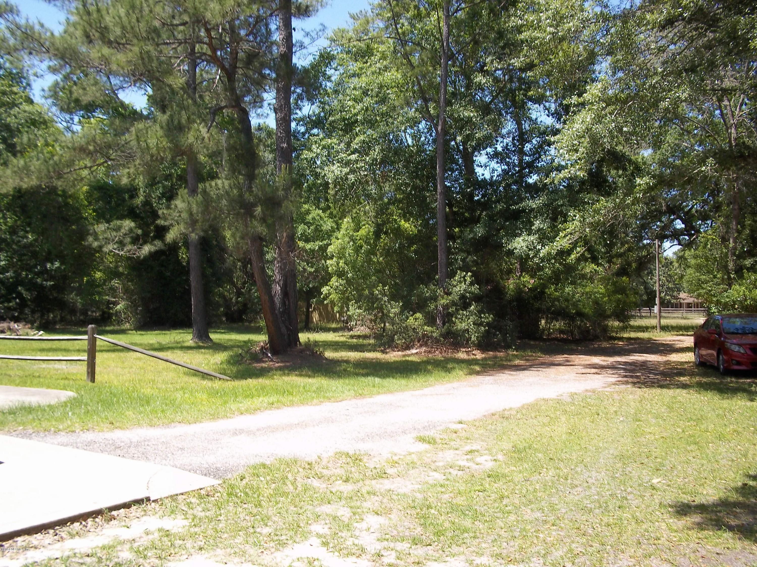 5579 Long Branch Road Jacksonville, FL 32234 - Photo 9 of 54 a view of yard with swimming pool and trees