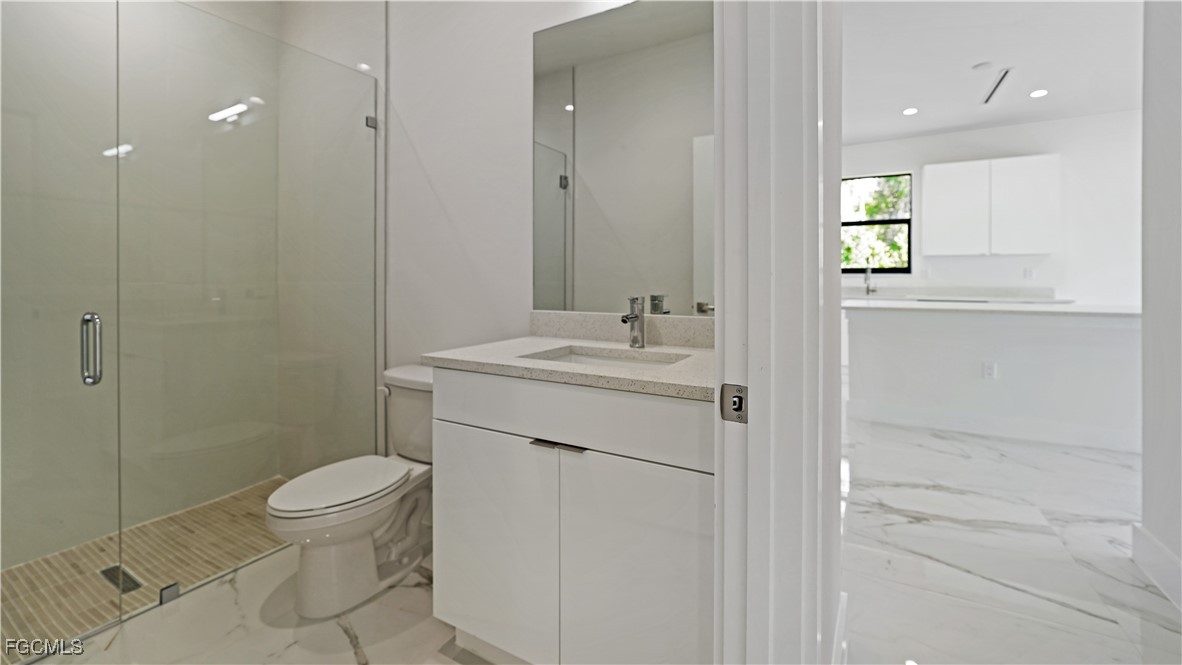 123 Ichabod Avenue Lehigh Acres, FL 33973 - Photo 25 of 42 a bathroom with a sink toilet and shower