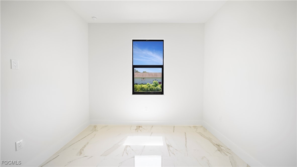 123 Ichabod Avenue Lehigh Acres, FL 33973 - Photo 33 of 42 a view of an empty room with a window