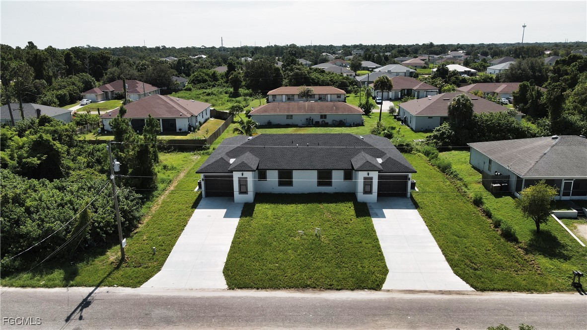 123 Ichabod Avenue Lehigh Acres, FL 33973 - Photo 5 of 42 an aerial view of multiple houses with a yard