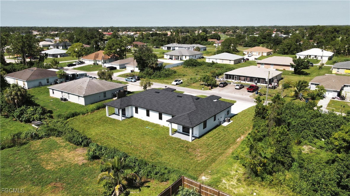 123 Ichabod Avenue Lehigh Acres, FL 33973 - Photo 9 of 42 an aerial view of residential houses with outdoor space and parking