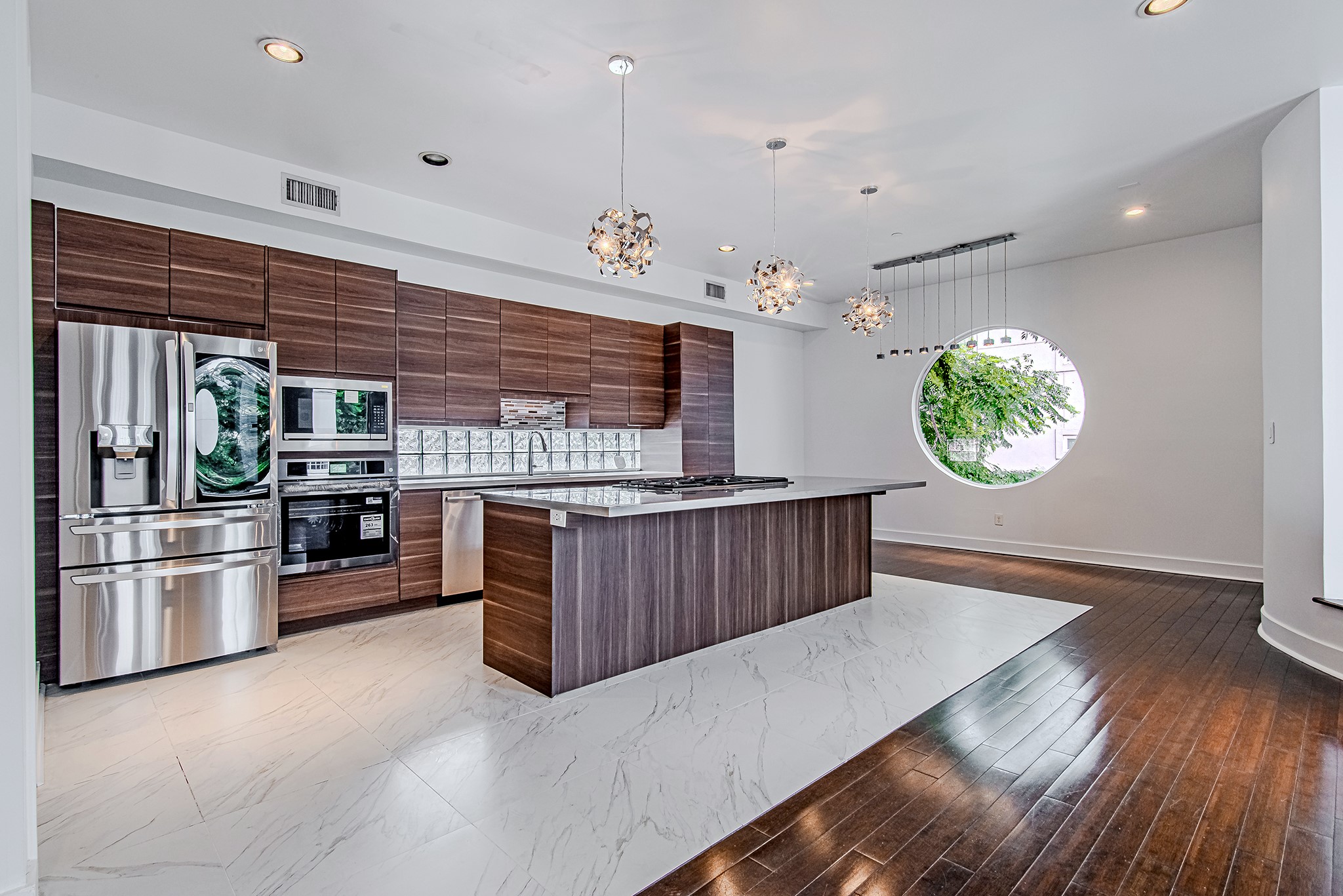 2025 Colquitt Street, Unit E Houston, TX 77098 - Photo 2 of 29 Open-concept kitchen with large island, ideal for both everyday living and entertaining.