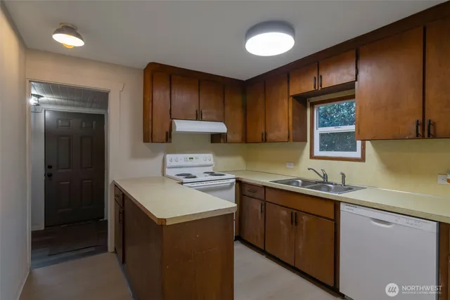 a kitchen with a sink stove and cabinets