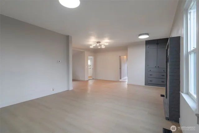 an empty room with a bathroom and a shower