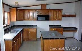 223 Crabapple Ridge Clyde, NC 28721 - Photo 3 of 3 a kitchen with stainless steel appliances granite countertop a stove a sink and a microwave