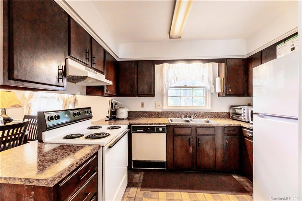 7518 Riding Trail Road Charlotte, NC 28212 - Photo 3 of 36 a kitchen with a stove a sink a refrigerator and window