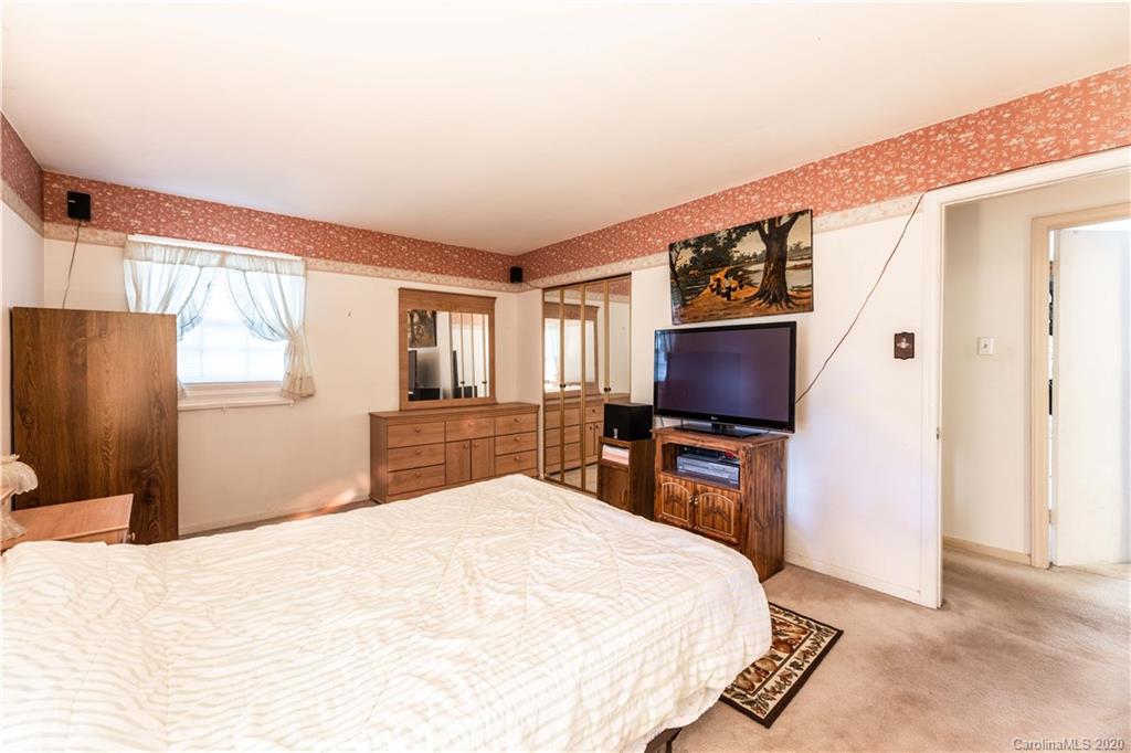 7518 Riding Trail Road Charlotte, NC 28212 - Photo 22 of 36 a bedroom with a bed and a flat screen tv