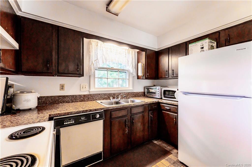 7518 Riding Trail Road Charlotte, NC 28212 - Photo 4 of 36 a kitchen with stainless steel appliances granite countertop a sink stove and refrigerator