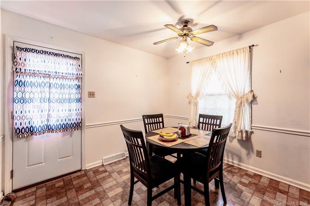 7518 Riding Trail Road Charlotte, NC 28212 - Photo 8 of 36 a view of a dining room with furniture and a chandelier fan
