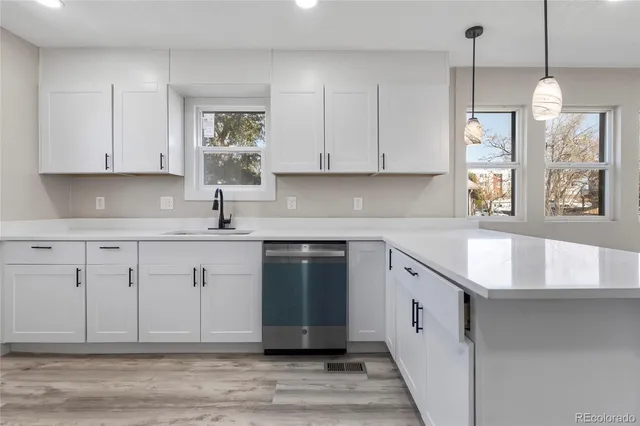 a kitchen with granite countertop a sink stainless steel appliances and cabinets