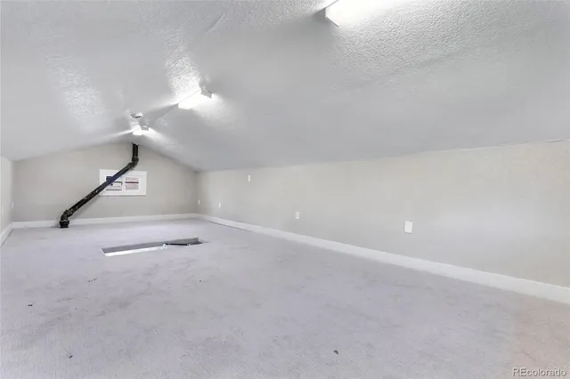 a view of a room with stairs and a ceiling fan