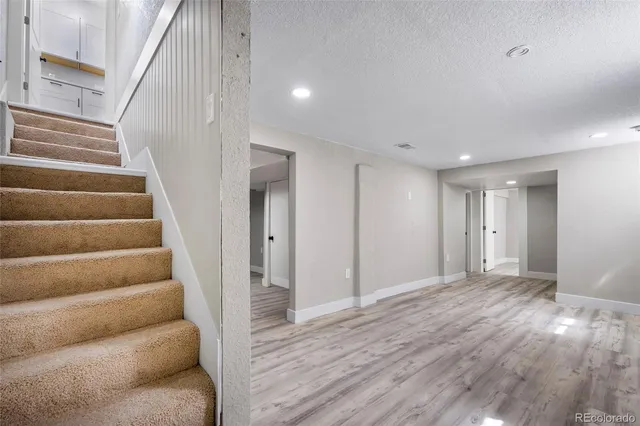 a view of entryway and hall with wooden floor