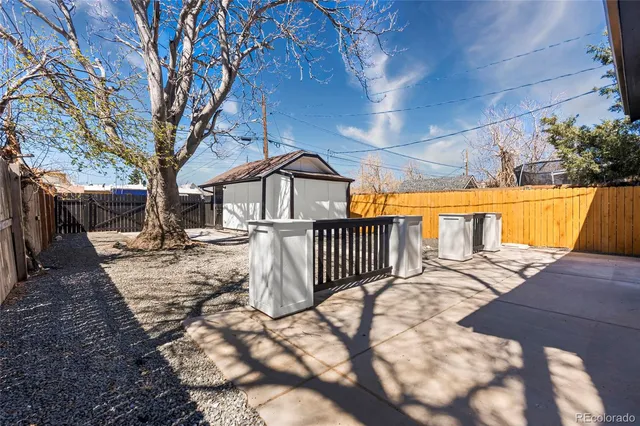 a view of a house with a small yard next to a yard