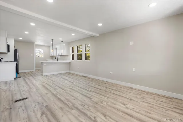 a view of a kitchen with a sink and a refrigerator