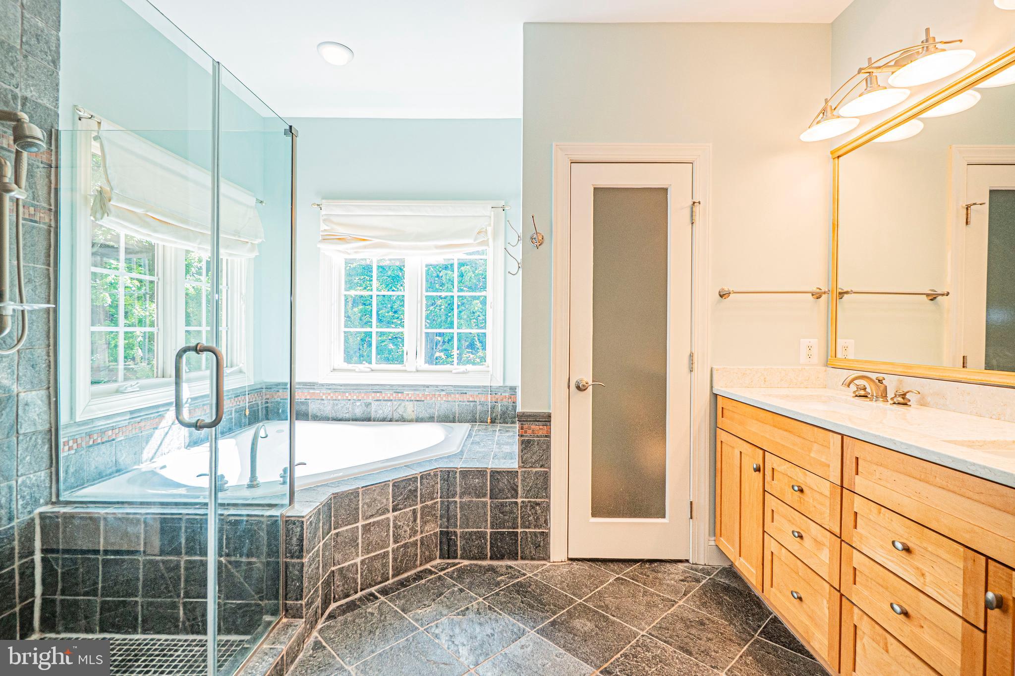 5448 Edsall Ridge Place Alexandria, VA 22312 - Photo 26 of 52 a bathroom with a double vanity sink a mirror and next to a window