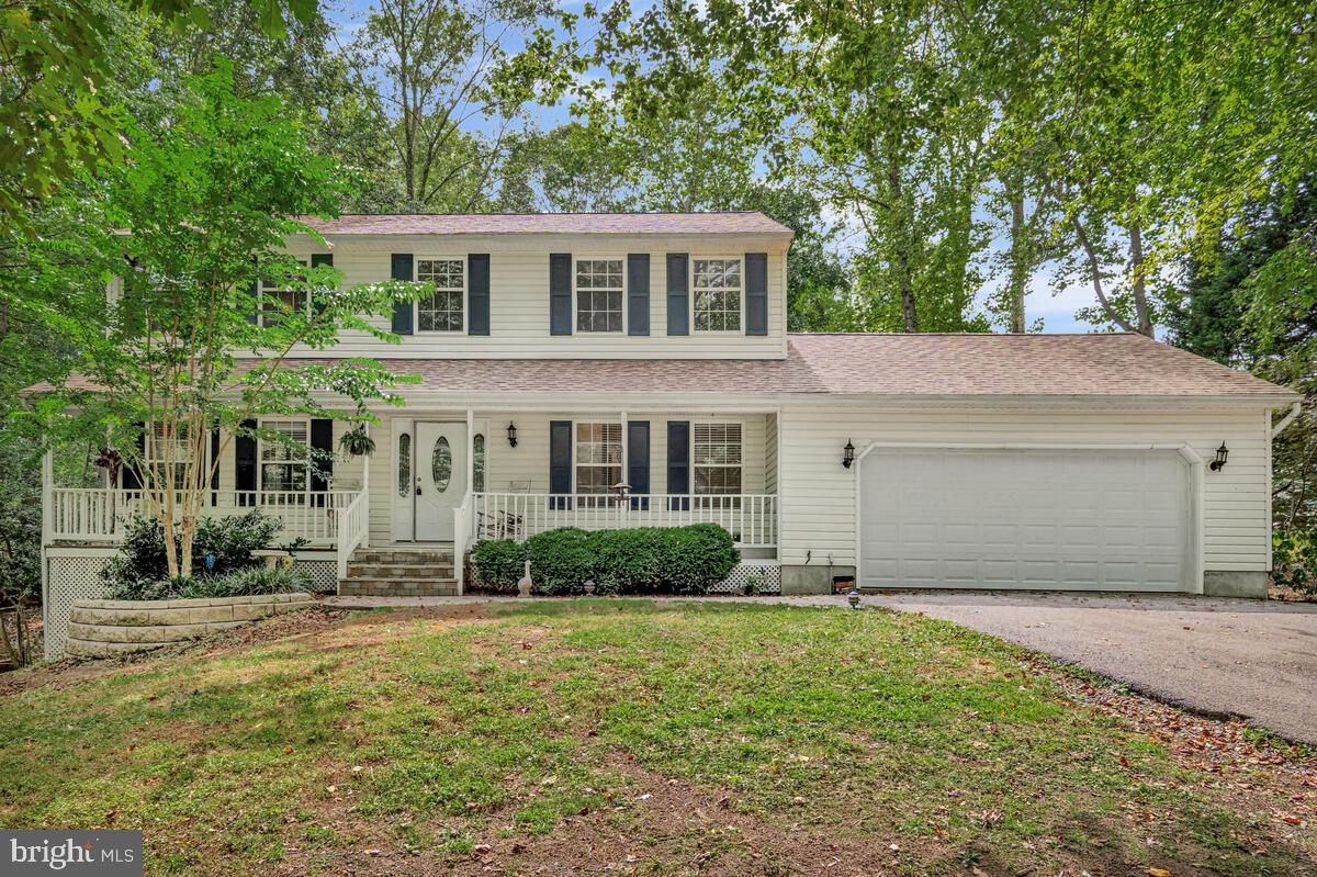 5963 Hillside Road St. Leonard, MD 20685 - Photo 1 of 54 a front view of a house with a yard and garage