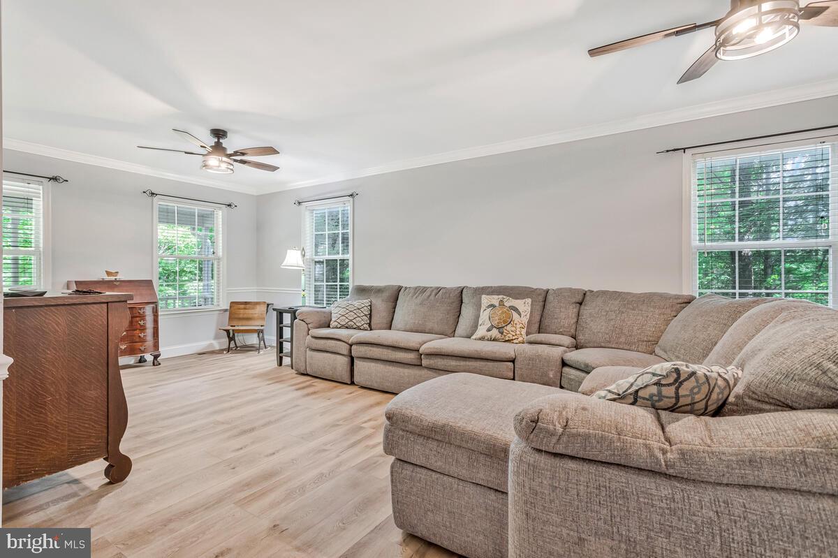 5963 Hillside Road St. Leonard, MD 20685 - Photo 11 of 54 a living room with furniture and a large window